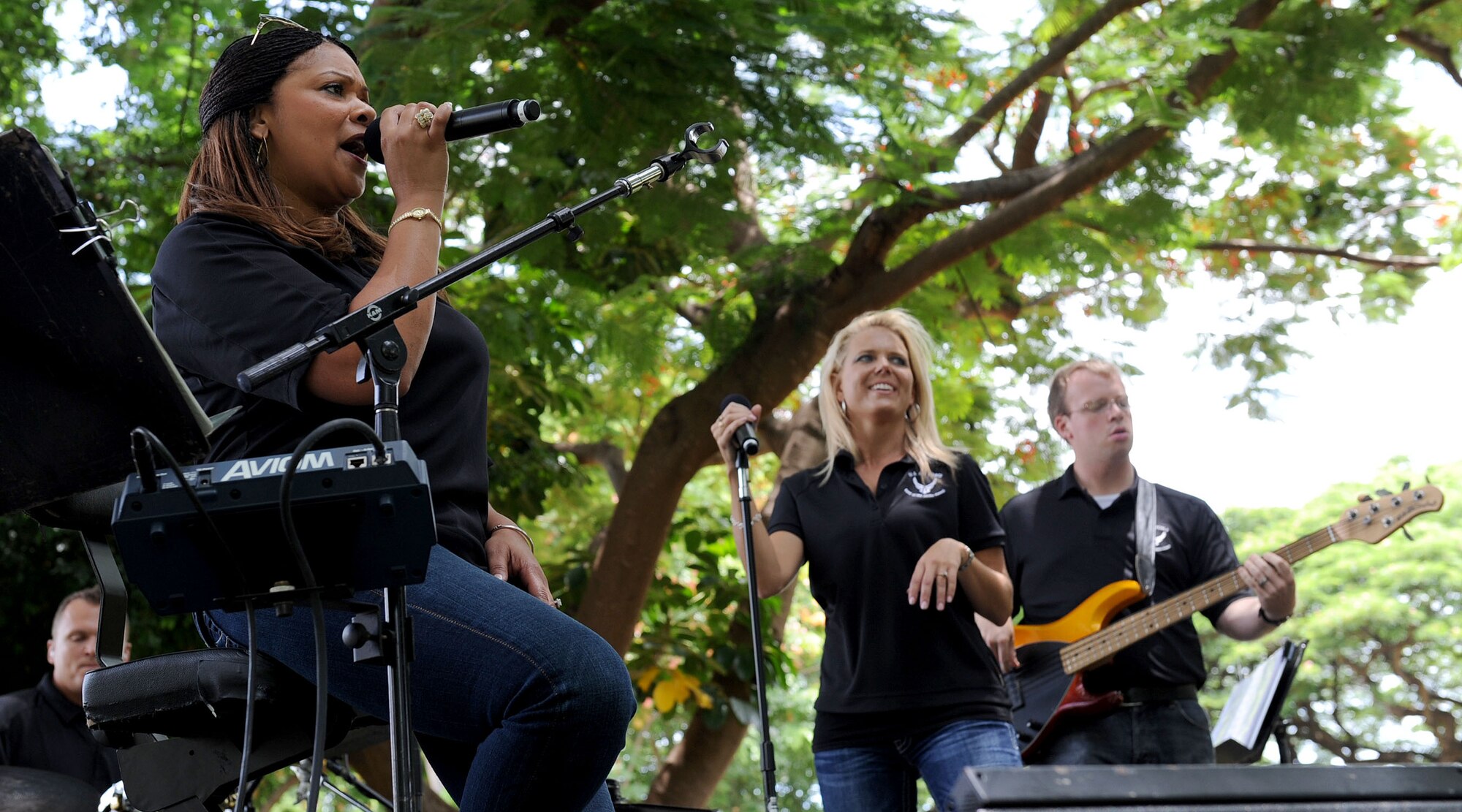 Tech. Sgt. Tamiko Boone, and Master Sgt. (select) Lara Murdzia, members of the U.S. Air Force Band of the Pacific-Hawaii “Hana Hou,” sing during Mahalo Bash 2011, at Joint Base Pearl Harbor-Hickam, Sept. 1.  The Mahalo Bash is an annual event hosted by the Pacific Air Forces commander to thank Airmen and their families for their service and hard work throughout the year. (U.S. Air Force photo/Tech. Sgt. Jerome S. Tayborn/Released)
