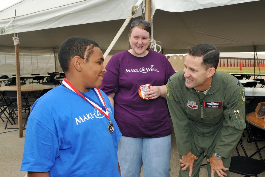 Wish child Javon Ellebb talks with U.S. Air Force Col. William Jensen, 55th Wing vice commander, during the 2011 Defenders of Freedom Special Needs Air Show at Offutt Air Force Base, Neb., Aug. 26. Wish children and their families enjoyed a day viewing various aircraft thanks to the Make-A-Wish Foundation, Offutt AFB and the various performers. (U.S. Air Force photo by Charles Haymond)