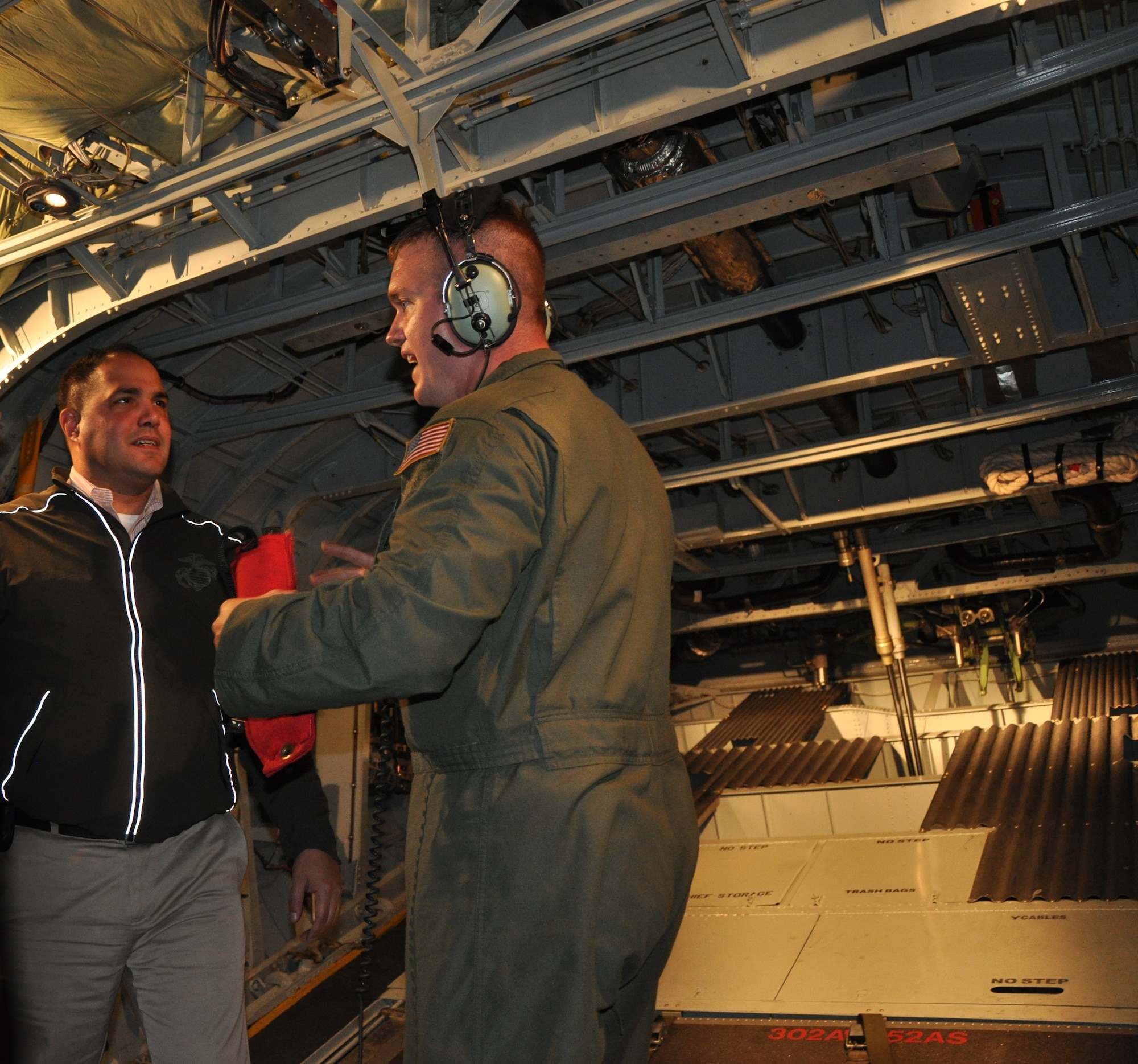 Javier Sanchez, Military Legislative Assistant (Representative Virginia Foxx, North Carolina-05), listens to Tech. Sgt. Adam Beaver, a C-130 loadmaster with the 302nd Airlift Wing's 52nd Airlift Squadron, explain how airdrop loads are rigged and released during an Aug. 25 Congressional Staff Delegation visit to Peterson Air Force Base. Sanchez and 11 other Congressional staff members participated in a three-day visit to Air Force Reserve units in Colorado, sponsored by the Directorate of Policy Integration, United States Air Force Reserve.The visit aimed to help participants learn, first-hand, about the various roles and missions of the Air Force Reserve. (U.S. Air Force photo/Ann Skarban)