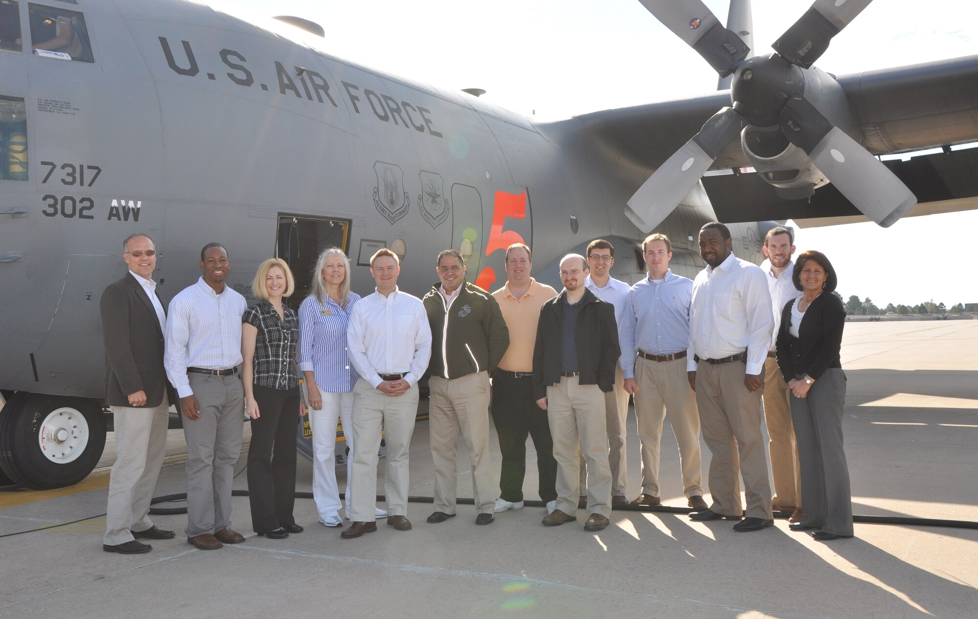 Congressional Representative staff members pose for a photo just prior to their orientation flight aboard a 302nd Airlift Wing, Air Force Reserve Command C-130 Aug. 25 at Peterson Air Force Base, Colo. The staff members participated in a visit to Air Force Reserve units in Colorado including the 302nd Airlift Wing, the 310th Space Wing and Air Force Reserve Personnel Center. The staff delegation visit was sponsored by the Directorate of Policy Integration, United States Air Force Reserve and helped the participants learn, first-hand, about the various roles and missions of the Air Force Reserve. Participants in the staff delegation visit included:  Mr. Ryan Berger, Legislative Director (Senator Bob Corker,Tennessee), Mr. Tim Welter, Legislative Director (Representative Todd Young, Indiana-09), Mr. Jim Dolbow, Legislative Director (Representative Austin Scott, Republican, Georgia-08), Mr. Dan Ziegler, Legislative Director (Representative Doug Lamborn, Colorado-05), Mr. Javier Sanchez, Military Legislative Assistant (Representative Virginia Foxx, North Carolina-05), Mr. Michael Weems, Military Legislative Assistant (Representative Joe Barton, Texas-06), Mr. Schylr Greggs, Policy Advisor (Representative Pete Sessions, Texas-35), Ms. Renee Doyle, Legislative Assistant (Representative Michele Bachmann, Minnesota-06), Mr. Sean McLean, Legislative Assistant (Representative Marsha Blackburn, Tennessee-07), Mr. Craig Dulniak, Military Legislative Assistant (Representative Steve Cohen,Tennessee-09), Mr. Clifton Williams, Legislative Assistant (Representative Marcia Fudge, Ohio-11). (U.S. Air Force photo/Ann Skarban)