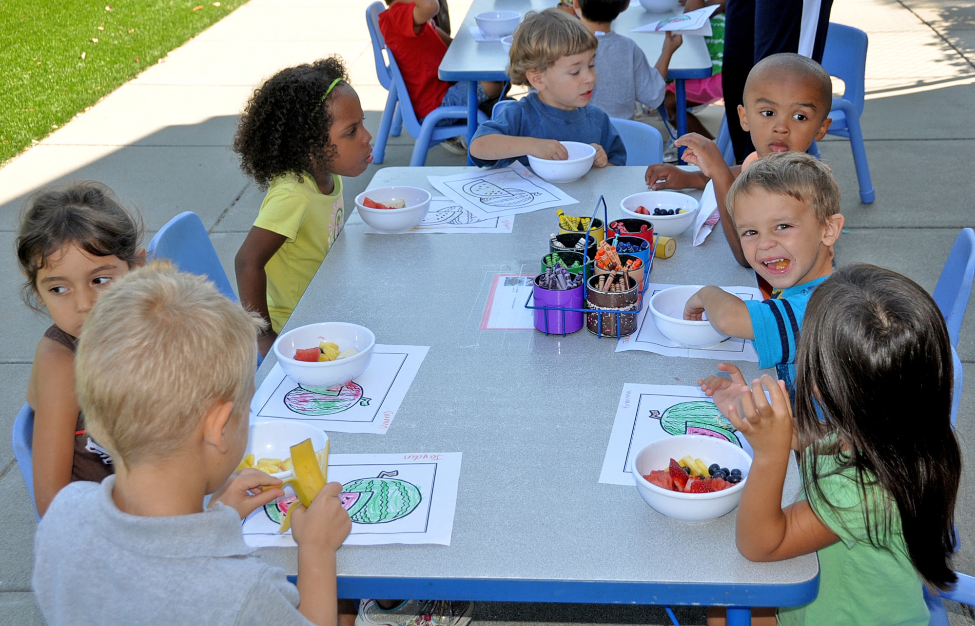Children from CDC No.3 learn about good nutrition while enjoying a watermelon banana split. (U.S. Air Force photo/ Airman Madelyn Ottem)