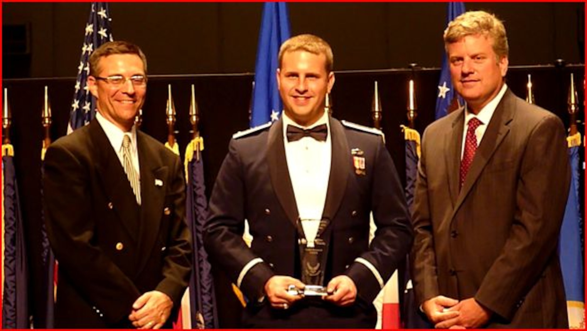 WRIGHT PATERSON AIR FORCE BASE, Ohio -- Second Lt. Michael Trubilla, 47th Operations Support Squadron,  receives the Air Force Science and Technology Cadet Research Award from Mark T. Maybury (left), the Chief Scientist of the Air Force , and Dr. Steven Walker (right), the deputy assistant secretary of science, technology  and engineering. Trubilla received the award for his research on propulsion solutions for satellites, which could save the Air Force hundreds of millions of dollars. (Photos courtesy of 2nd Lt. Michael Trubilla)