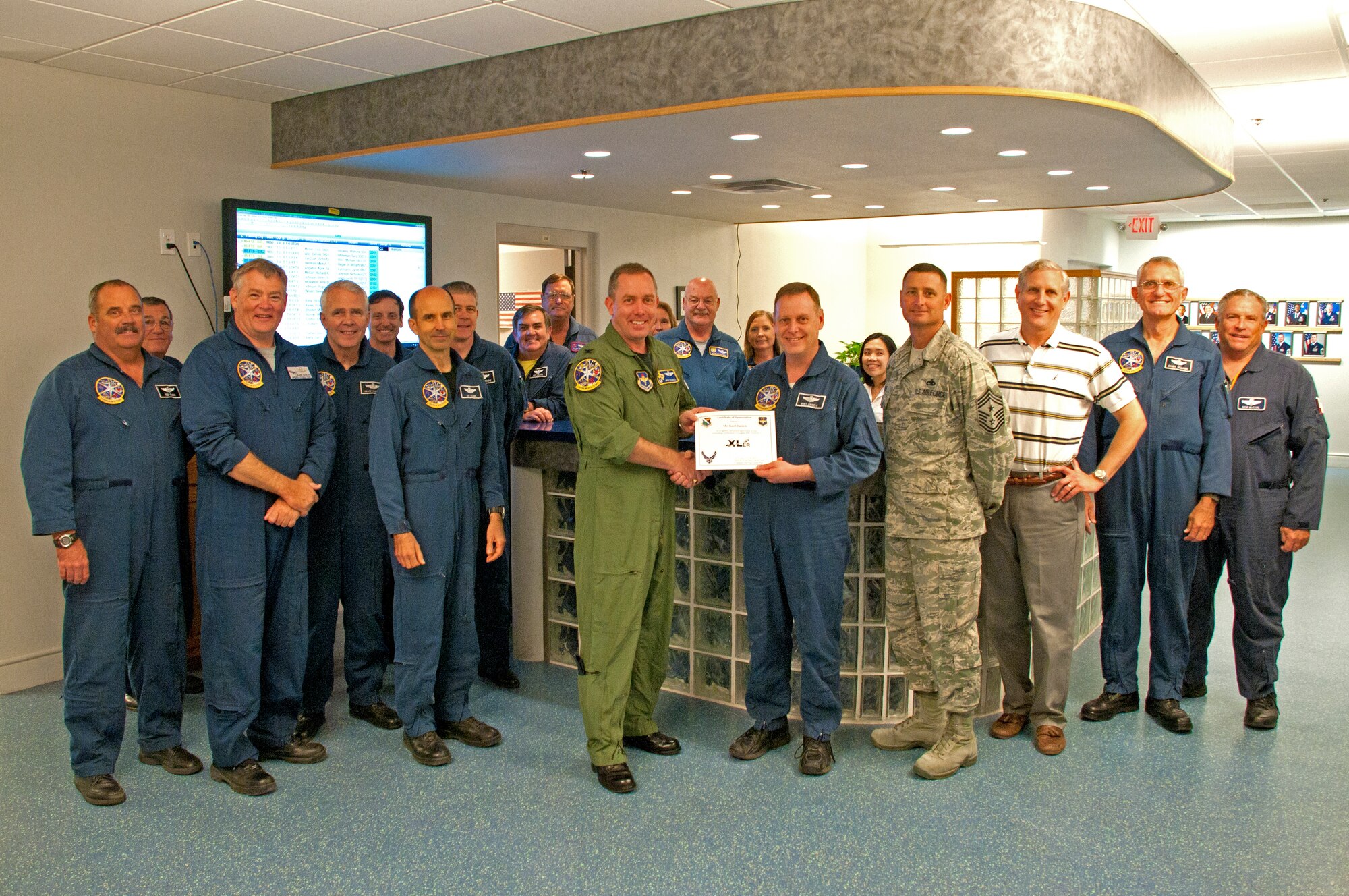 LAUGHLIN AIR FORCE BASE, Texas – Kurt Daniels, 47th Operations Group T-6 Texan II simulator instructor, poses with Col. Michael Frankel, 47th Flying Training Wing commander, after being presented the XLer of the Week award here Aug. 31. The XLer is a weekly award chosen by wing leadership and given to those who consistently make outstanding contributions to Laughlin and their unit. (U.S. Air Force photo/Senior Airman Scott Saldukas)