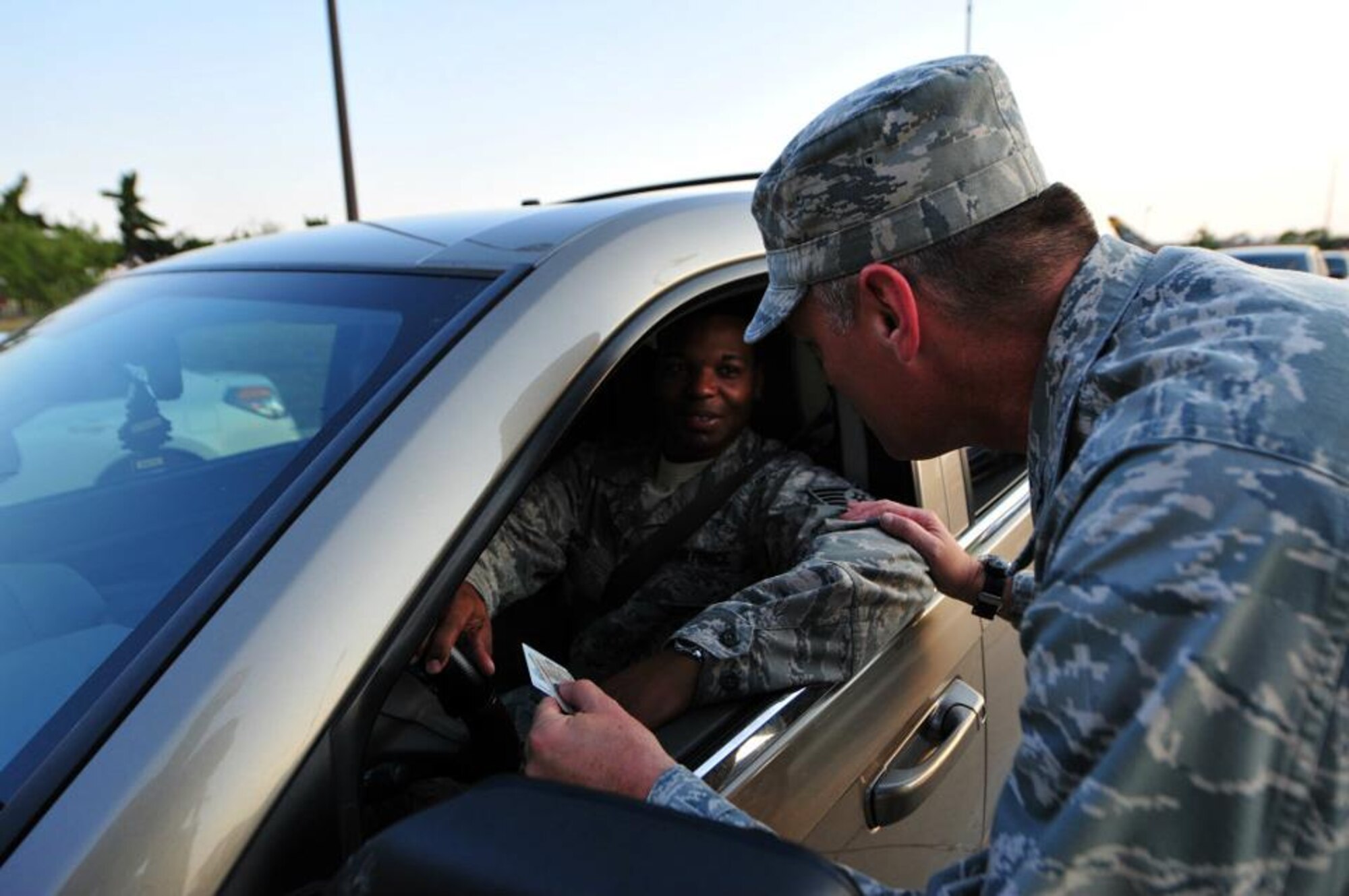 Col. Charles Carlton,22nd Medical Group commander, greets an Airman as he arrives at the front gate during the “Be Safe, Have a Plan” campaign Sept. 1, 2011, at McConnell Air Force Base, Kan. Senior leaders from the base greeted Airman, family members and civilian employees at the gate to encourage them to make responsible decisions. (U.S. Air Force photo by Senior Airman Courtney Witt)

