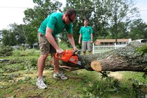 Capt Mark Prusinowski uses a chainsaw to trim a downed tree in the community of Goldsboro, N.C., Aug. 30, 2011. The storm left many residents without power and fallen trees were the cause of most structural damage. Prusinowski, 335th Fighter Squadron pilot from Seymour Johnson Air Force Base, is a native of Phoenix. (U.S. Air Force photo by Senior Airman Rae Perry /Released)