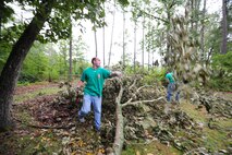 Capt. Matt Bar tosses a branch after cutting it from a larger limb at a resident?s yard in the community of Goldsboro, N.C., Aug. 30, 2011. When Hurricane Irene?s outer bands hit the community near Seymour Johnson Air Force Base, N.C., it was a category one storm dumping close to 10 inches of rain with sustained winds of 34 mph and gusts up to 48 mph. Bar, 335th FS pilot, is a native of Brunswick, Ohio. (U.S. Air Force photo by Senior Airman Rae Perry /Released)