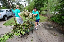 Capt. Crystal Kirkley places debris in a wheelbarrow for removal in the Goldsboro area Aug. 30, 2011. The 335th Fighter Squadron at Seymour Johnson Air Force Base, N.C., volunteered to aid the community after Hurricane Irene toppled trees and caused power outages across eastern N.C. Kirkley, 335th FS weapons system officer, hails from Riverside, Calif. (U.S. Air Force photo by Senior Airman Rae Perry /Released)