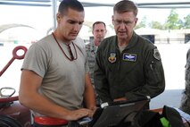 Airman 1st Class Shane Washburn, 4th Aircraft Maintenance Unit crew chief, answers questions about a technical order on the flightline on Seymour Johnson Air Force Base, N.C., Aug. 31, 2011. Maj. Gen. Stephen Hoog, 9th Air Force commander, asked Washburn about the pros and cons of using a technical order while working on an F-15E Strike Eagle. Washburn hails from Duluth, Minn. (U.S. Air Force photo by Senior Airman Whitney Lambert/Released)