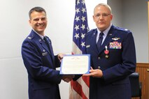 Col. Brian Kirkwood, 4th Operations Group commander, presents Maj. David Evans from the 4th Operations Support Squadron, with a Bronze Star Medal during a ceremony on Seymour Johnson Air Force Base, N.C., Sept. 1, 2011. Evans was awarded the medal for his role as lead fire support officer of a joint task force that supported both Operations Iraqi and Enduring Freedom. (U.S. Air Force photo by TSgt Daphne Adams)