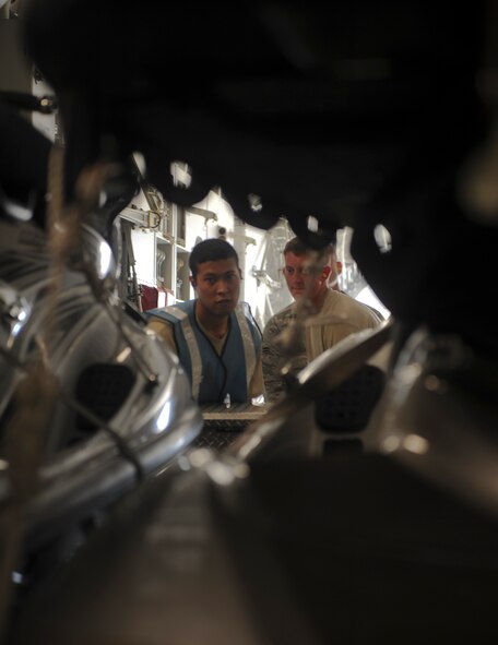 U.S. Air Force Staff Sgt. Christopher Caffee, 23rd Logistics Readiness Squadron flight dispatch, and Airman 1st Class Timothy Barnwell, 23rd LRS air transportation craftsman, load cargo into the back of a C-17 Globemaster III aircraft in preparation for the 38th Rescue Squadron’s deployment at Moody Air Force Base, Ga., Aug. 26, 2011. Members from the 23rd LRS loaded various kinds of gear including jet skis and all terrain vehicles. (U.S. Air Force photo by Airmen 1st Class Nicholas Benroth/Released)