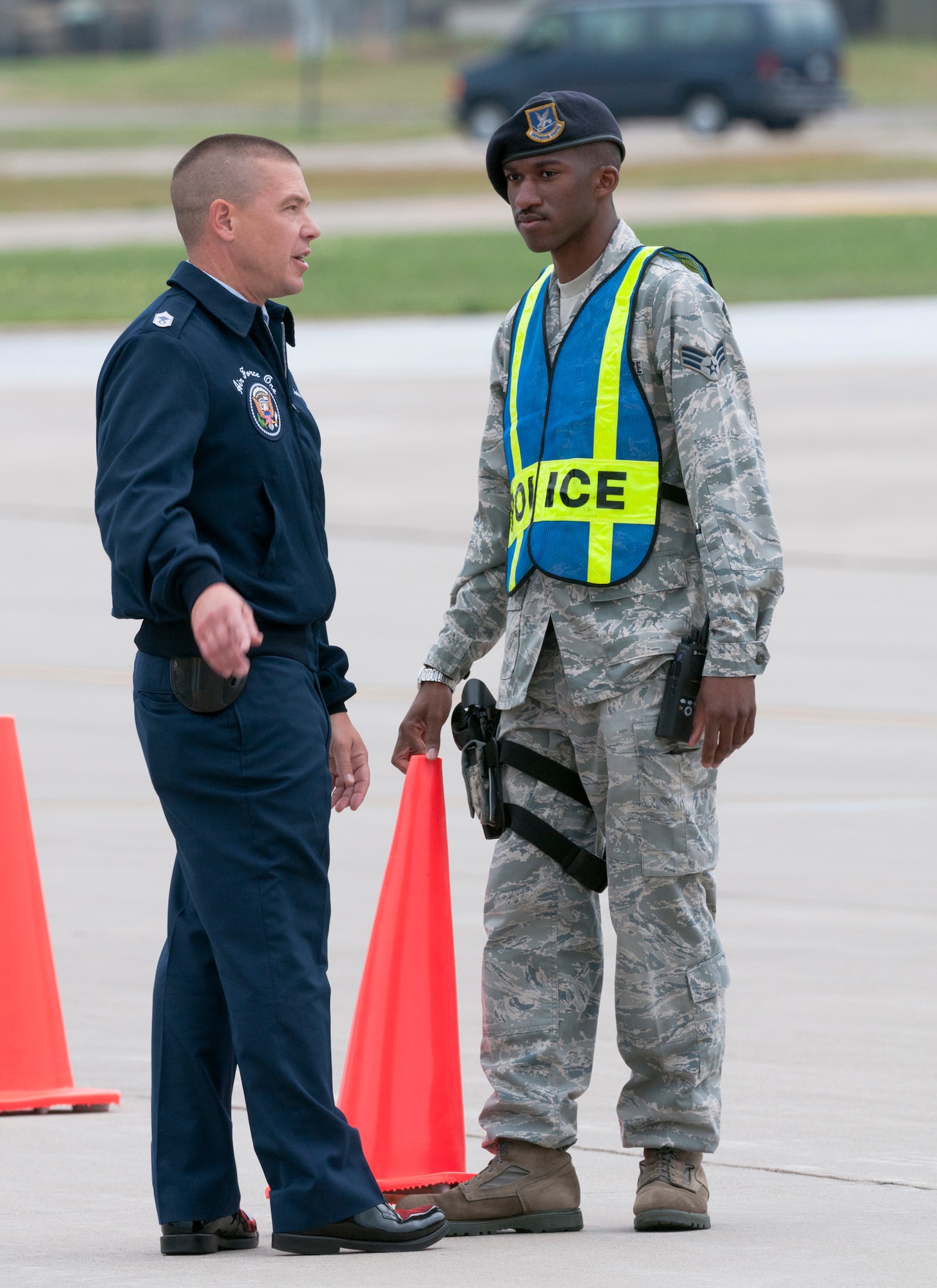 Senior Airman Durrell Motley (right) of the 133rd Security Forces Squadron places cones at the direction of a member of the Presidential Airlift Group, marking a perimeter surrounding Air Force One on Aug. 30, 2011. Air Force One, the VC-25A which is a highly customized Boeing 747-200B, arrived at the Minnesota Air National Guard base bringing the commander-in-chief to the Twin Cities where he delivered a speech to the American Legion Annual Conference. The visit is heavily supported with security, logistics, media and other support by the Airmen of the 133rd Airlift Wing. USAF official photo by Senior Master Sgt. Mark Moss