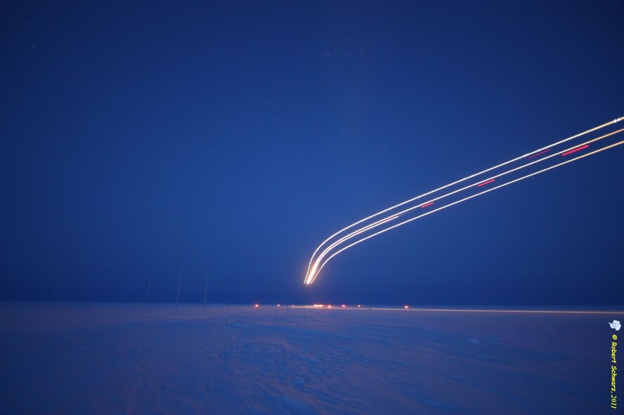 Time lapsed image of a C-17 Globemaster III flying over after dropping urgently needed medical supplies near the Amundsen-Scott South Pole Station .  The supply drop is part of Operation Deep Freeze (ODF) and in support of the U.S. Antarctic Program, which is managed by the National Science Foundation (NSF). ODF is an annual U.S. Air Force-led mission to lend operational and logistical support to the National Science Foundation's research and exploration in Antarctica.(courtesy image/Robert Schwarz)(Released)