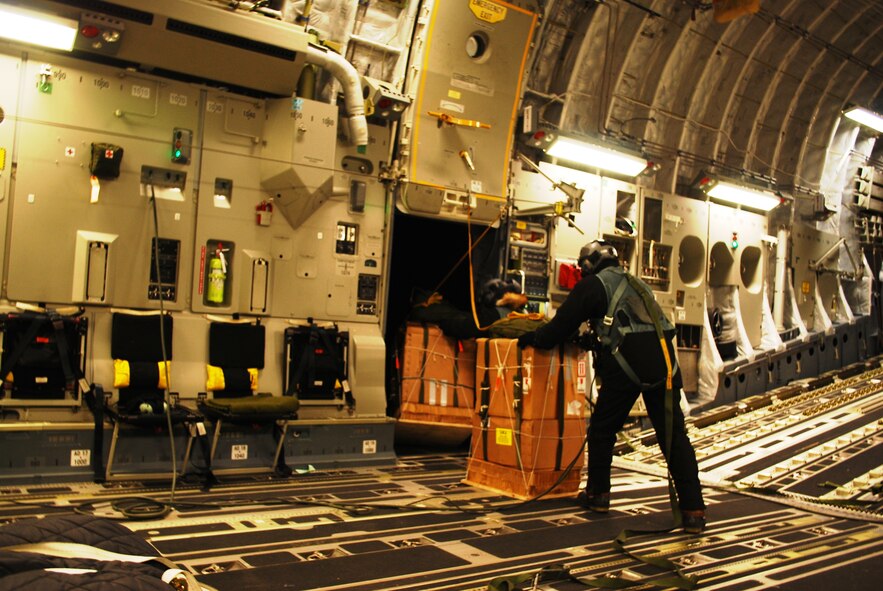 A C-17 Globemaster III loadmaster, forward-based with the 304th Expeditionary Airlift Squadron at Christchurch, New Zealand, prepares to airdrop urgently needed medical supplies near the Amundsen-Scott South Pole Station. The supply drop is part of Operation Deep Freeze and in support of the U.S. Antarctic Program, which is managed by the National Science Foundation. ODF is an annual U.S. Air Force-led mission to lend operational and logistical support to the National Science Foundation's research and exploration in Antarctica. (Courtesy image/Chief Master Sgt. Jim Masura)

