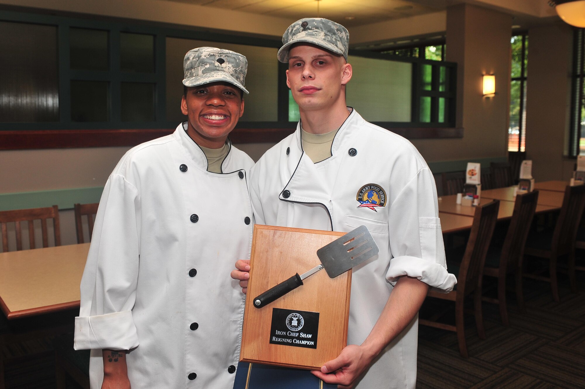 U.S. Army Specialists Debra Looney and Kurt O'Connor, 3rd Army food 
specialists, pose with their plaque as the winners for the Iron Chef 
Competition at Shaw Air Force Base, S.C. Aug. 31, 2011. The teams were tasked 
to produce one entre and one appetizer using what was provided in the kitchen 
and the surprise ingredient of red cabbage. The products were judged on the 
categories of taste, presentation, creativity and incorporation of the special 
ingredient. (U.S. Air Force photo by Airman 1st Class Ashley Gardner)