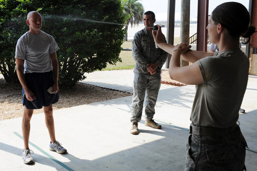 U.S. Air Force Staff Sgt. Jennifer Hall, 23rd Security Forces Squadron (SFS) corrections non-commissioned officer, practices how to properly spray oleoresin capsicum, better known as pepper spray, at Moody Air Force Base, Ga., Aug. 31, 2011. Airmen from the 23rd SFS trained on how to use pepper spray as an alternative to using lethal force. (U.S. Air Force photo by Senior Airman Ciara Wymbs/Released) 