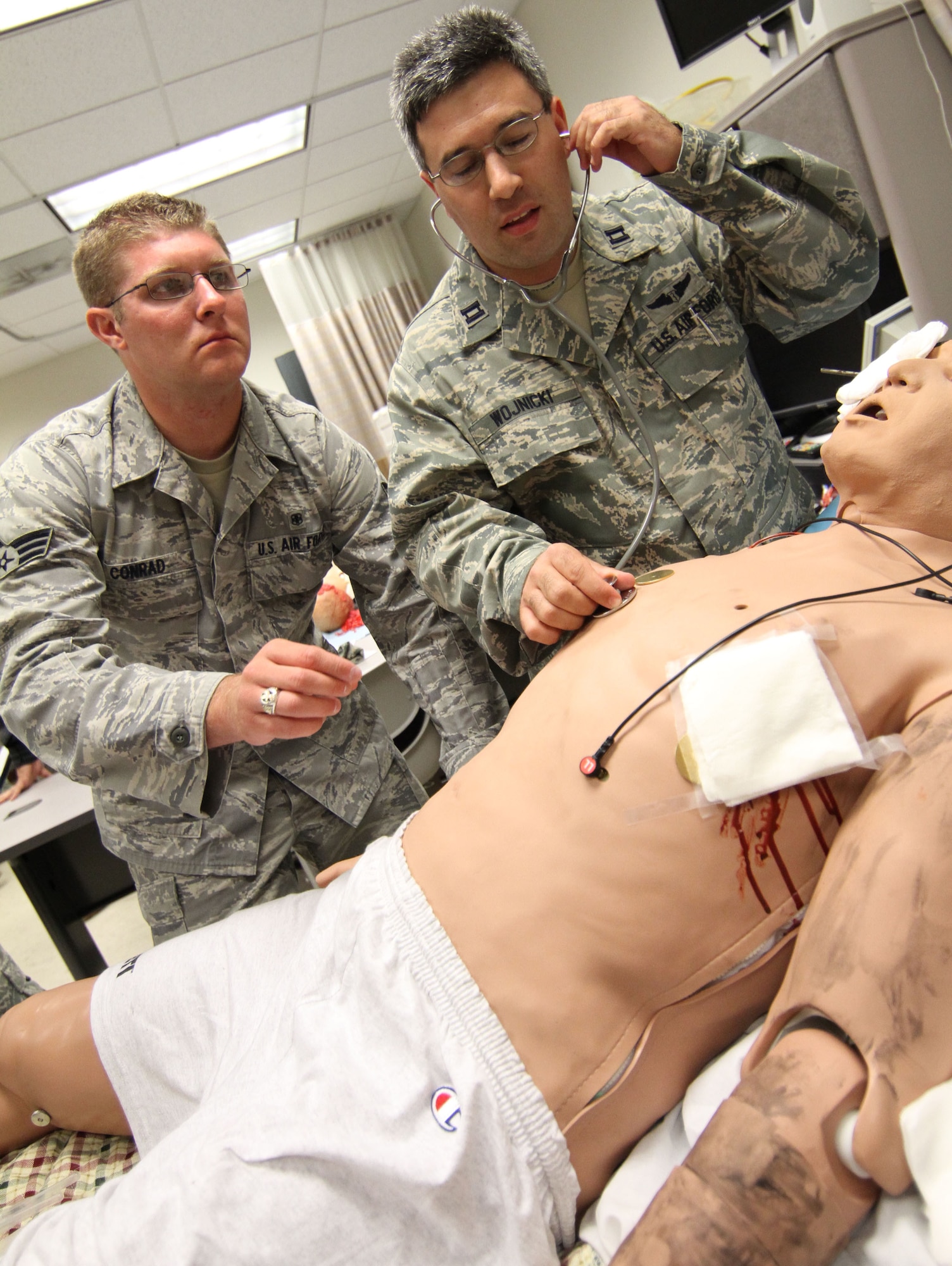 Senior Airman Nicholas Conrad and Capt. Jared Wojnicki check vital signs of "Sim-Man."  The simulated patient is a hi-tech training aid that allows Air Force reservists to maintain their proficiency skills. Also, Sim-Man can be programmed to exhibit a range of medical conditions. Conrad and Wojnicki are members of the 932nd Airlift Wing, Air Force Reserve, located at Scott Air Force Base, Ill. (U.S. Air Force photo/Tech. Sgt. Christopher Parr)