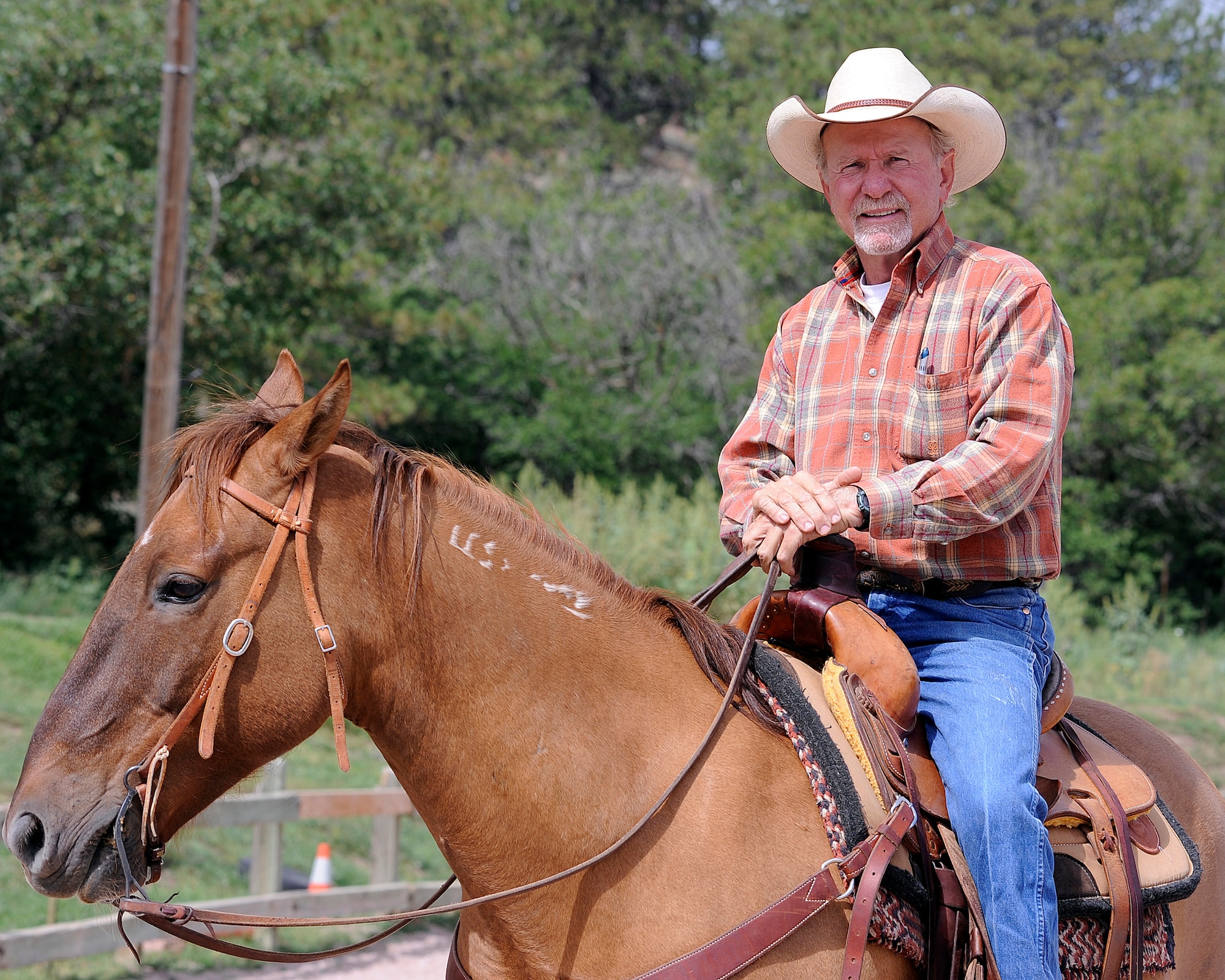 Andy Popejoy is helping to develop a hunting and fishing program for wounded warriors at the Air Force Academy in Colorado Springs, Colo. The former Colorado Outfitters Association president, pictured here at the Academy's Equestrian Center Aug. 28, 2011, also volunteers in the Equestrian Center's Warrior Wellness Program, which uses the principles of equine-assisted psychotherapy to restore battle-scarred service members' mental and emotional health. (U.S. Air Force photo/Mike Kaplan)