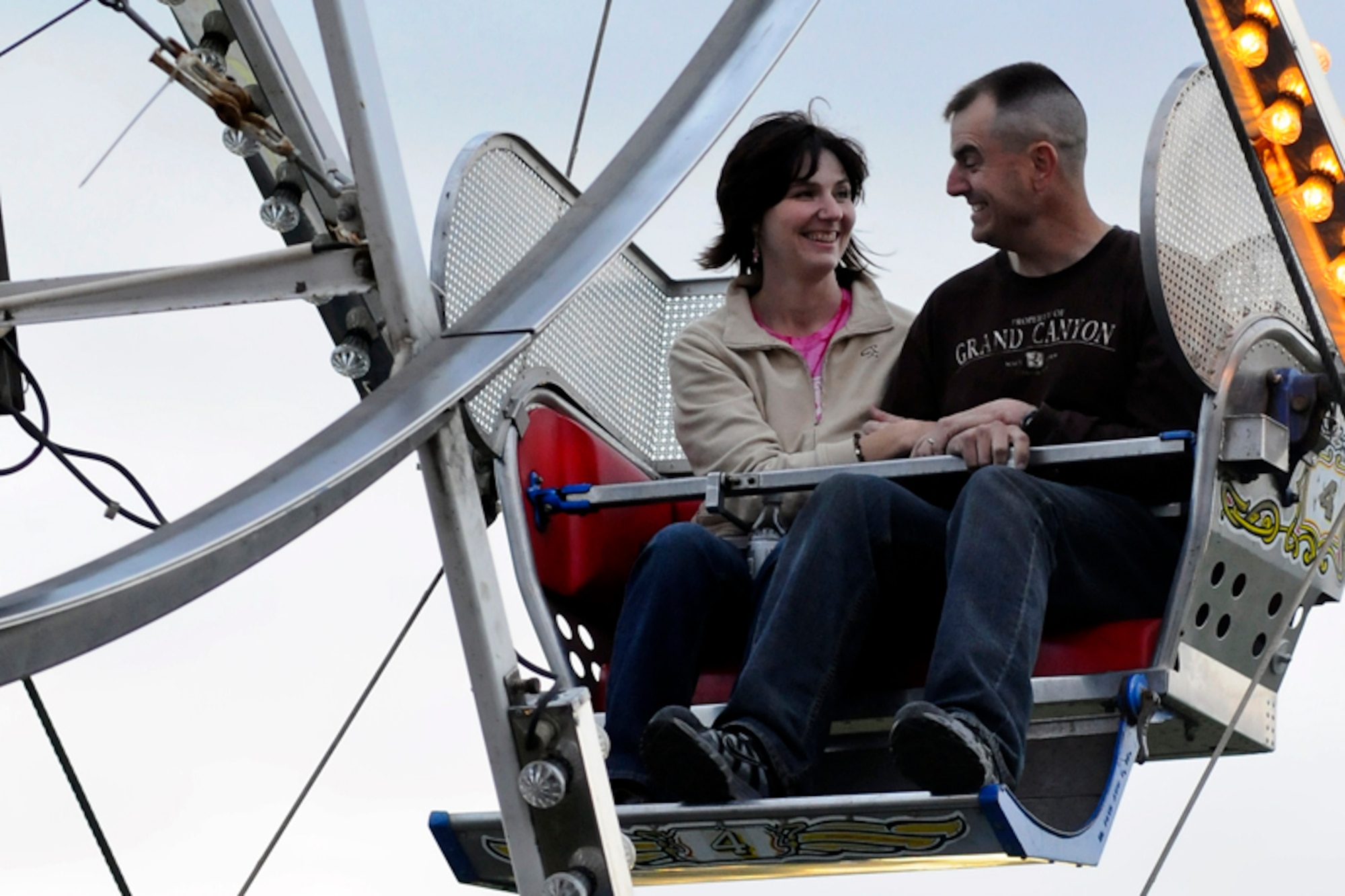 PALMER - Capt. James Williamson, Headquarters and Headquarters Company, 3d Maneuver Enhancement Brigade, and his wife Heather, enjoy a ride on the ferris wheel at the Alaska State Fair Aug. 26. Thousands turned out for a day of amusement rides, games, exhibits, live entertainment, and plenty of foodThe fair runs until Labor Day, Sept. 5., with several different events and acts each day.  For more information log on to the Alaska State Fair website at http://www.alaskastatefair.org.  (U.S. Air Force photo/Percy G. Jones)