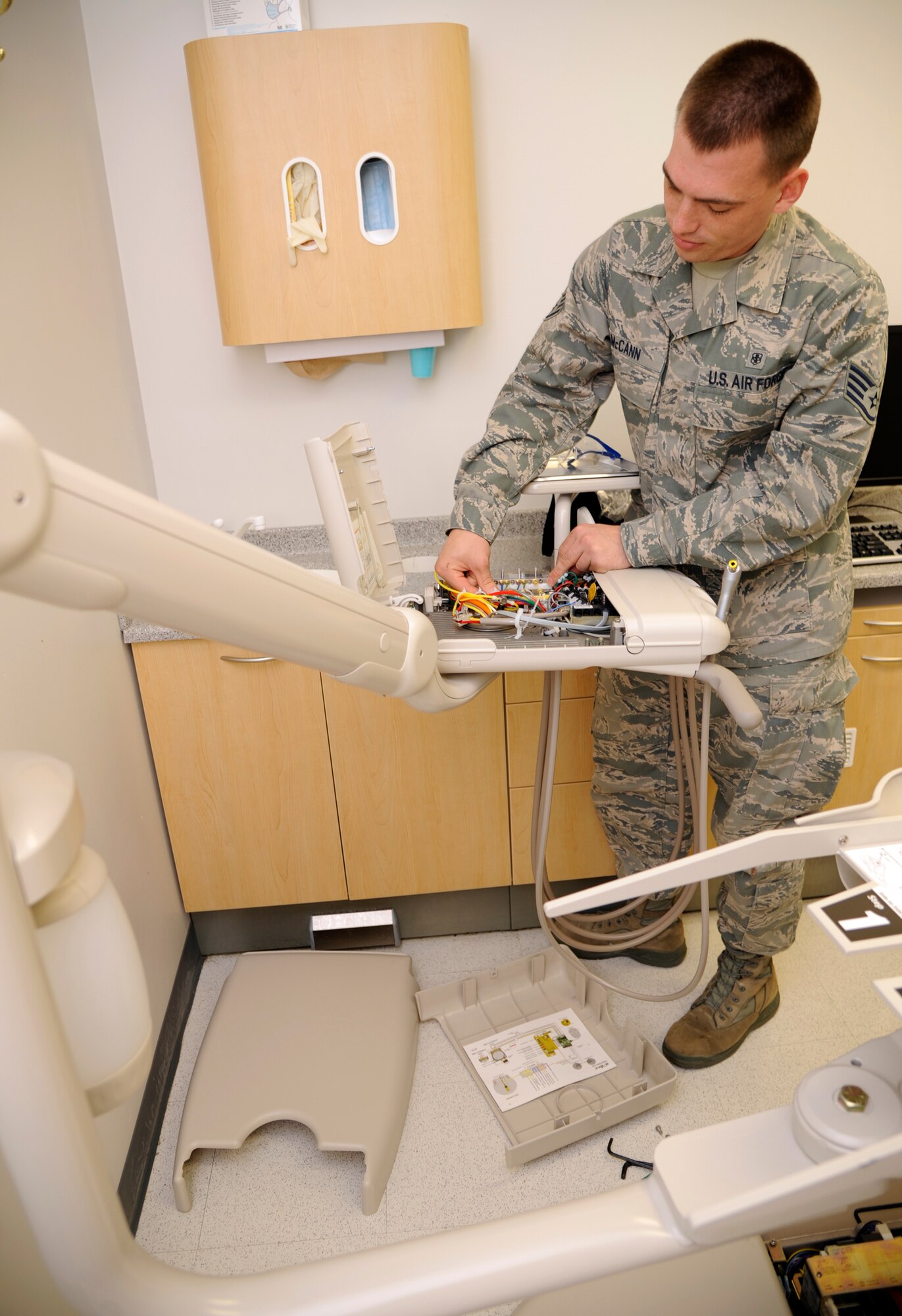 WHITEMAN AIR FORCE BASE, Mo.-  Staff Sgt. David McCann, Medical Support Squadron medical maintenance technician, connects wiring in a dental chair Aug. 26, at the base clinic. Medical maintenance has the crucial job of ensuring all medical machinery is serviceable, so the base clinic here can safely treat its monthly average of 5,000 patients. (U.S. Air Force photo/Senior Airman Cody H. Ramirez)