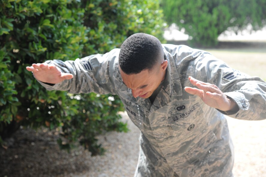 U.S. Air Force Senior Airman Zachary Walker, 23rd Security Force Squadron (SFS) patrol leader, proceeds to an eye rinse station after finishing the five combat stations during pepper spray training at Moody Air Force Base, Ga., Aug. 31, 2011. The training was conducted so 23rd SFS Airmen would know how to defend themselves if they were ever sprayed. It also helped them understand the effects of pepper spray on potential aggressors. (U.S. Air Force photo by Airman 1st Class Paul Francis/Released)
