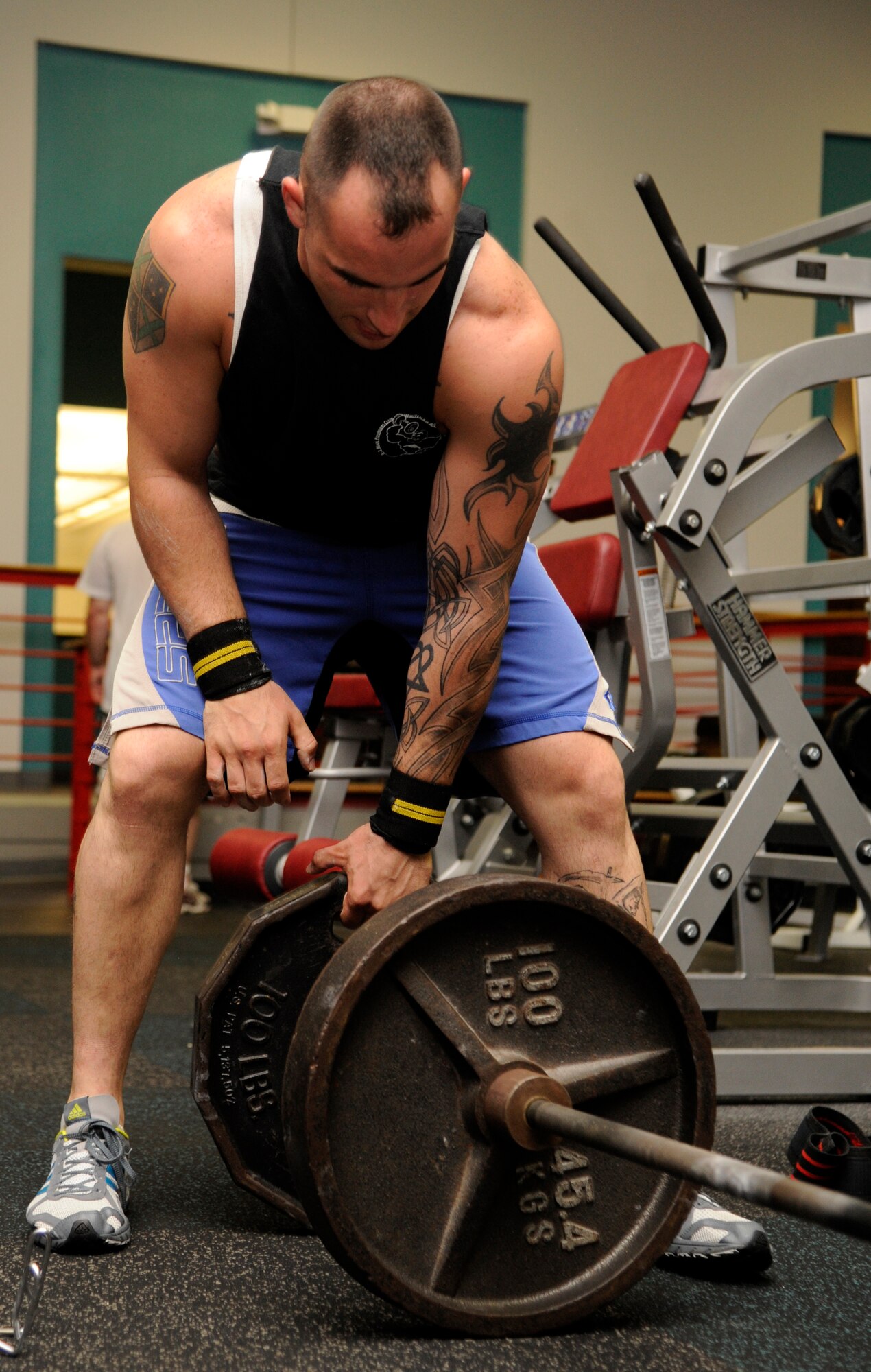 WHITEMAN AIR FORCE BASE, Mo. - Army Sergeant Stephen Kirkbride, Missouri National Guard, 1-135th Aviation Reconnaissance Battalion, adds 100 pounds to his dead-lift bar while working out at the fitness center here, Aug. 22. Kirkbride broke the 2011 Missouri State Fair Amateur Dead-lift Competition with a 550-pound lift, shattering the previous record of 515 pounds. (U.S. Air Force photo/Senior Airman Cody H. Ramirez)