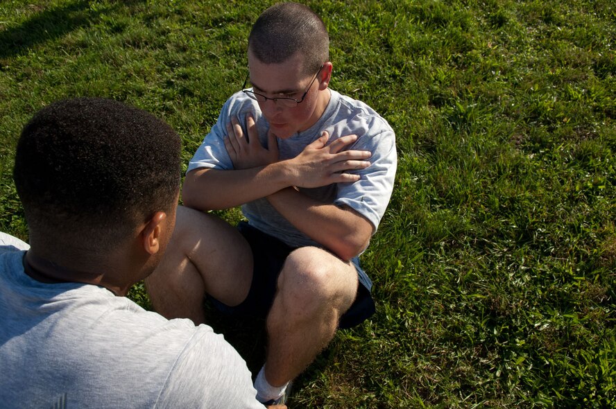 HANSCOM AIR FORCE BASE, Mass. – Airman 1st Class Caleb Kearby, 66th Force Support Squadron, completes the sit-ups portion of the Unit Fitness Challenge outside the fitness center Aug. 24. After the 5K race, units were invited to participate in the challenge. FSS won the competition. (U.S. Air Force photo by Rick Berry)