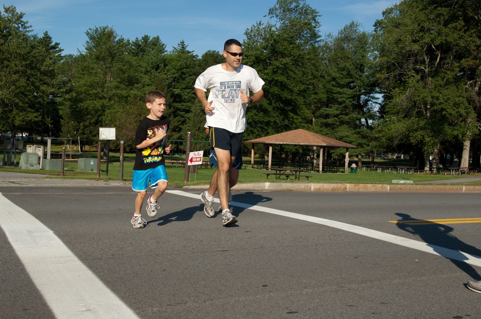 HANSCOM AIR FORCE BASE, Mass. – Carter Baumann (left) finishes his first 5K race beside his father during the Dogs Days of August 5K Aug. 24. The race, organized by the fitness center, was open to the entire Hanscom community. (U.S. Air Force photo by Rick Berry)