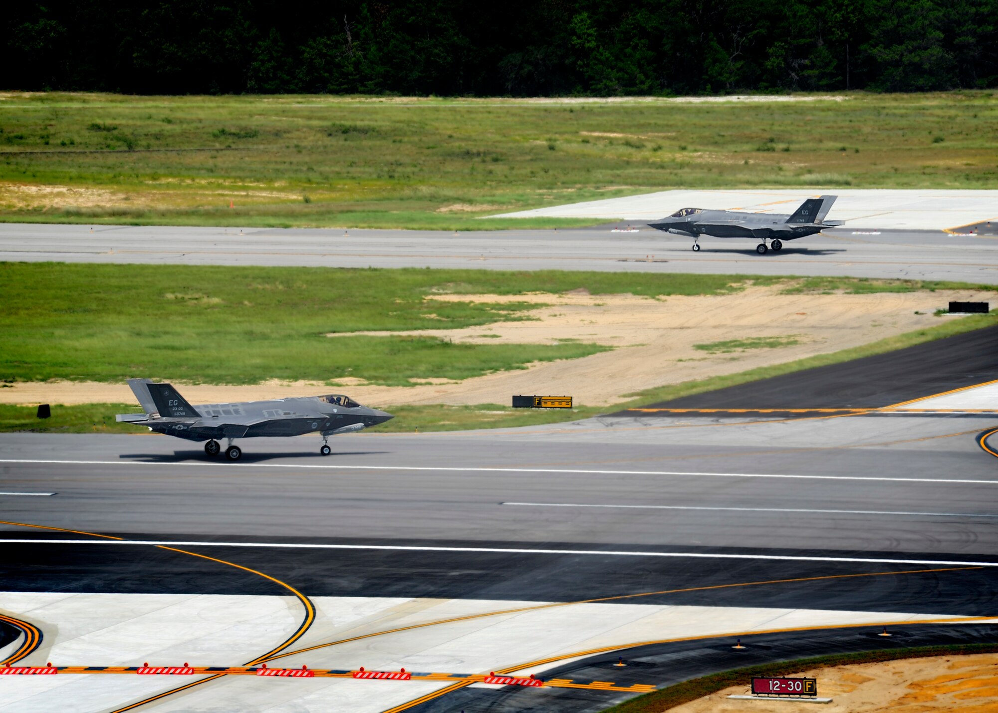 Two more F-35A Lightning II joint strike fighters were delivered to Eglin with 33rd Fighter Wing piloted F-16s escorting the jets to their new home Aug. 31. Labeled as AF-10 and AF-11 by Lockheed Martin, the JSFs bring the total count of the fifth generation fighter aircraft here to four. The aircraft here are used for JSF maintenance training until all certifications are complete. More F-35s are scheduled to arrive at Eglin this year, including at least one short takeoff/vertical landing (STOVL) variant, BF-6. (U.S. Air Force photo/Staff Sgt. Joely Santiago)
