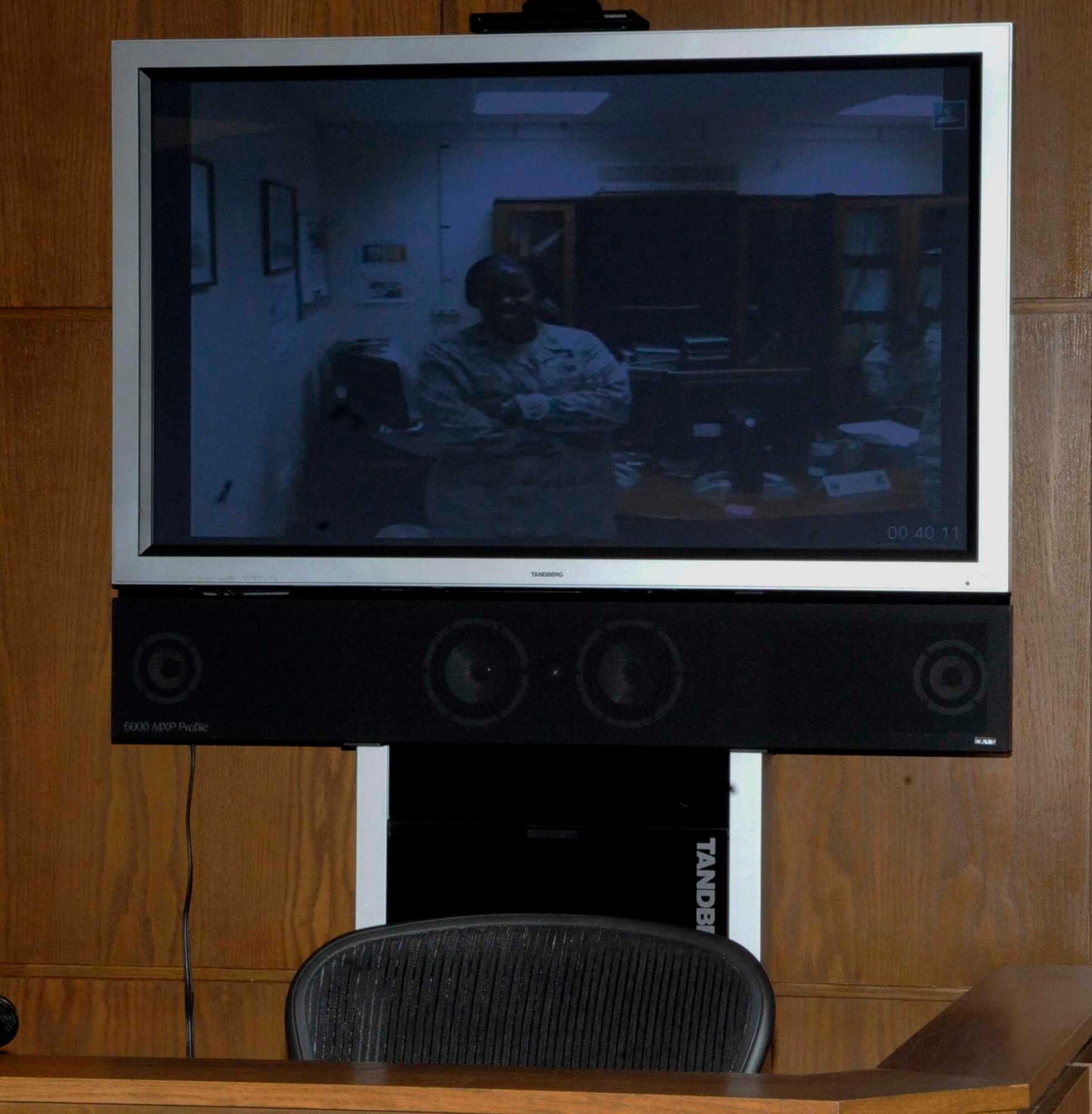 Capt. Capri Baptiste, Staff Sgt. Geoffery Gunn's younger sister, watches the promotion ceremony from her deployed location in Southwest Asia via a video teleconference Aug. 31. In addition to Baptiste, Gunn's wife, daughter and parent's attended the ceremony. (U.S. Air Force photo/Staff Sgt. Terri Barriere) (RELEASED)