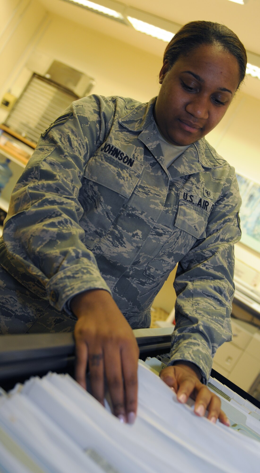 ROYAL AIR FORCE LAKENHEATH, England - Senior Airman Brittany Johnson, 48th Aerospace Medical Squadron public health technician, files papers on Sept. 1, 2011. Johnson was nominated for a Liberty Spotlight because she displays the core value of "Excellence in All We Do". (U.S. Air Force photo/Airman Cory Payne) 
