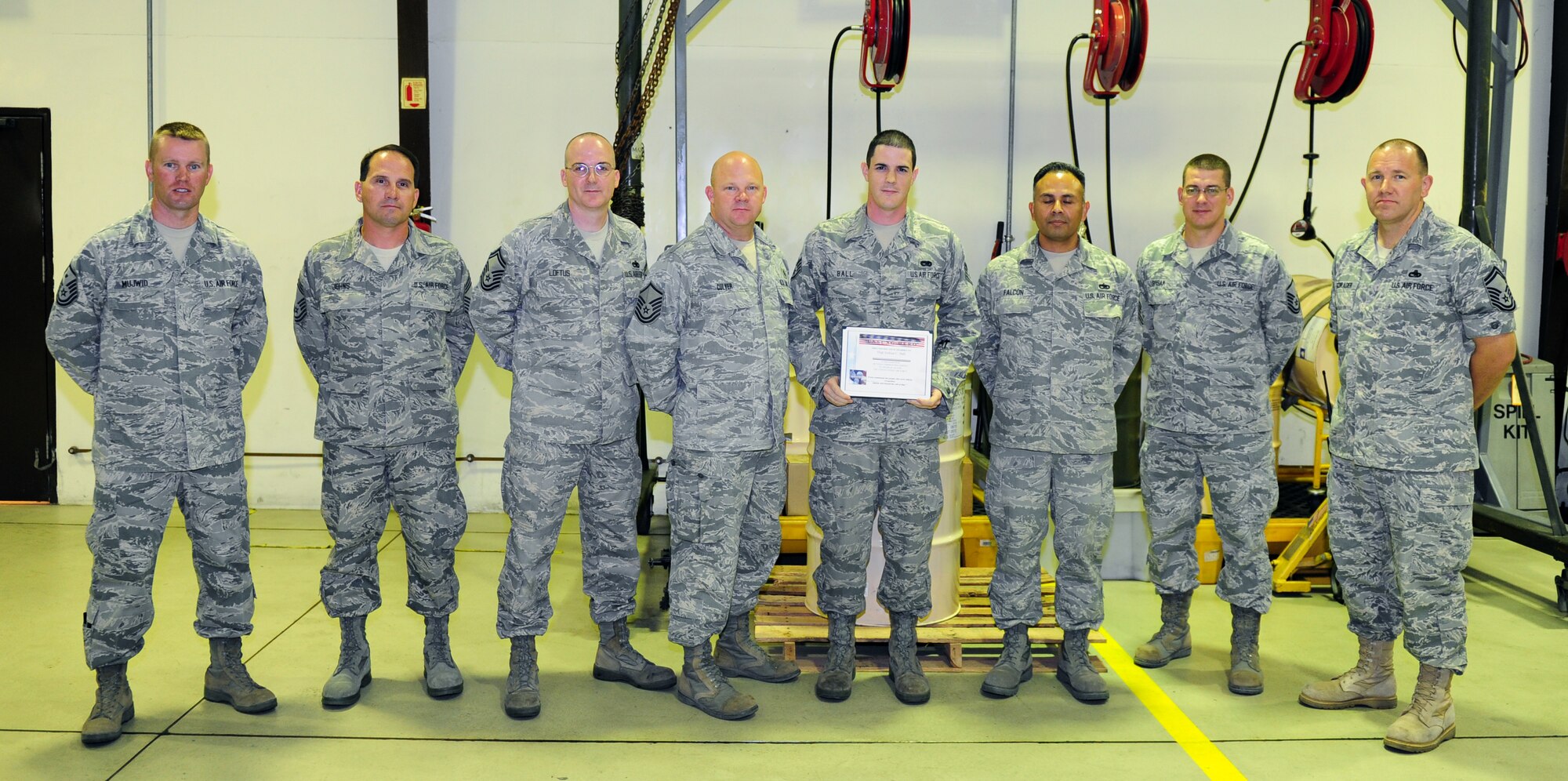 Staff Sgt. Joshua Ball, 39th Maintenance Squadron, receives the Unsung Hero Award from members of the Incirlik Top 3 Sept. 1, 2011, at Incirlik Air Base, Turkey. The Top 3 presents this award monthly to Airmen who demonstrate superior job performance and exceptional leadership. (U.S. Air Force photo by Senior Airman Anthony Sanchelli/Released)
