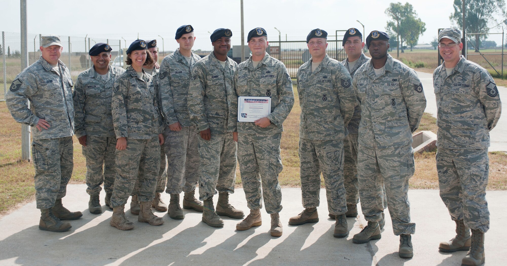 Staff Sgt. William Hancock, 39th Security Forces Squadron, receives the Unsung Hero Award from members of the Incirlik Top 3 Sep. 1, 2011, at Incirlik Air Base, Turkey. The Top 3 presents this award monthly to Airmen who demonstrate superior job performance and exceptional leadership. (U.S. Air Force photo by Senior Airman Clayton Lenhardt/Released)