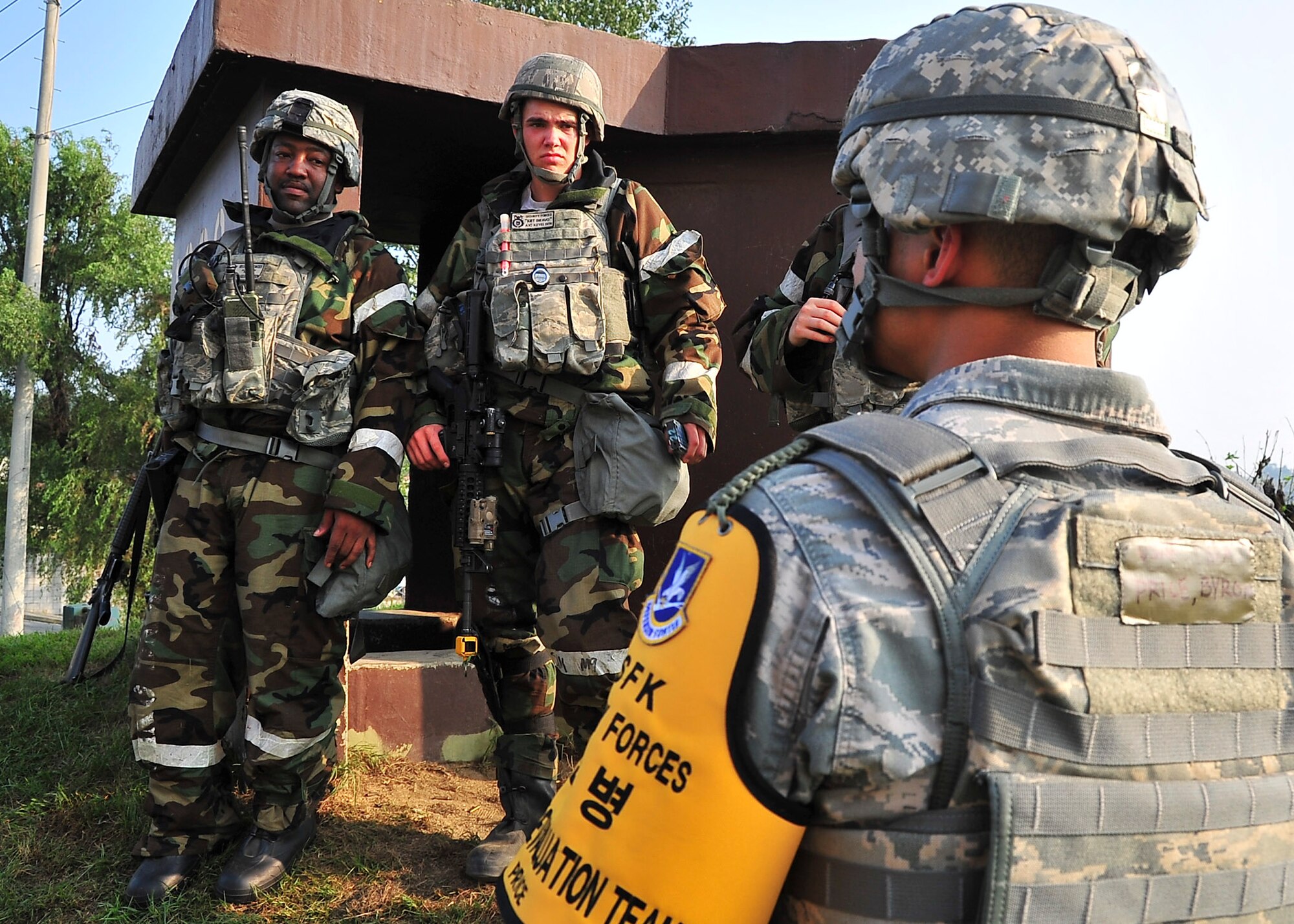 Airmen from the 51st Security Forces Squadron listen as their critiqued on their decisions during a small arms attack by Senior Airman Byron Price, 51st Security Forces Squadron exercise evaluator, Sep. 01, 2011 during exercise Beverly-Midnight 11-04. Exercises such as this test Osan's ability to survive and operate during a war-time constraint. (U.S. Air Force photo/Senior Airman Adam Grant