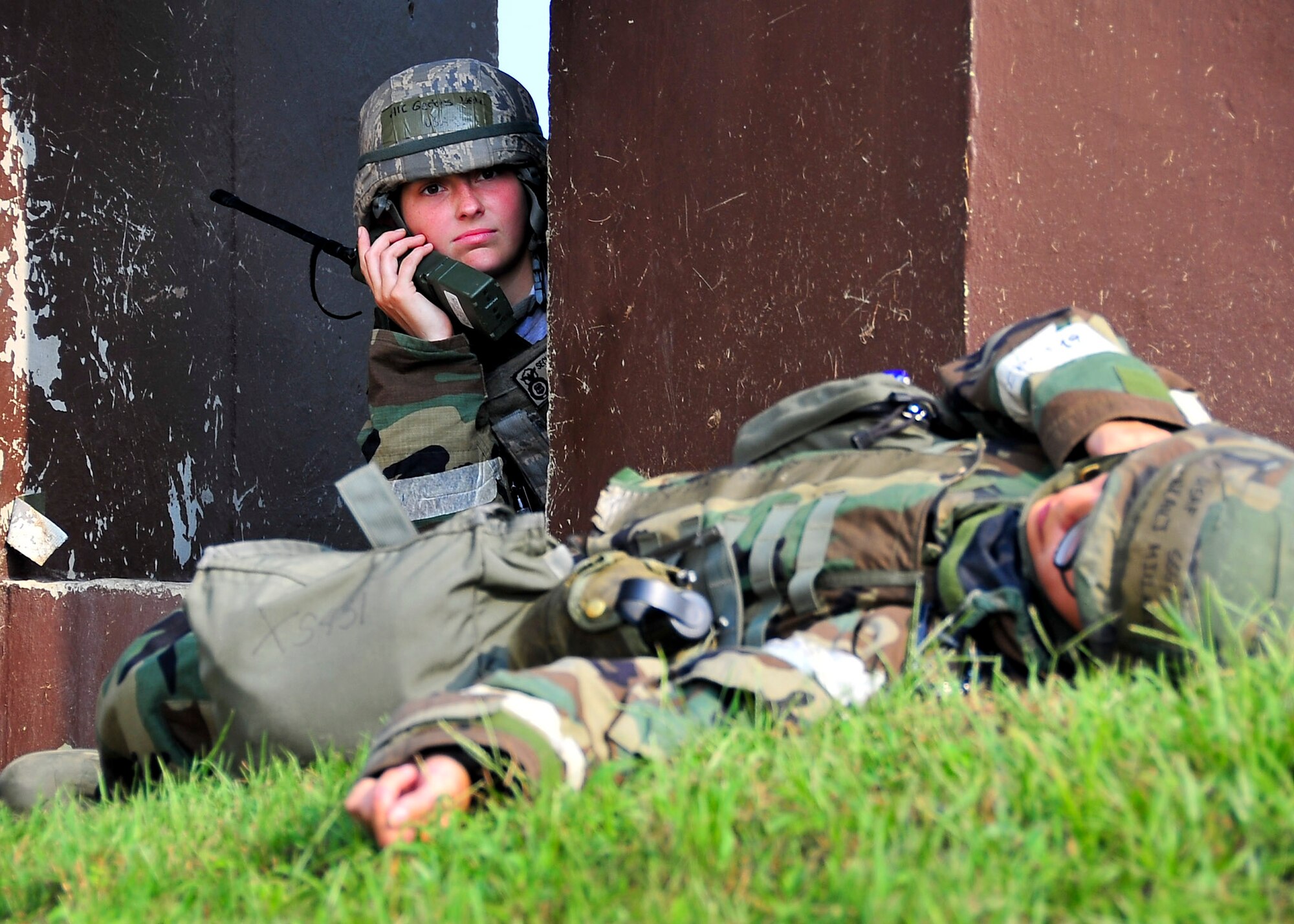 Airman 1st Class Leslie Gerbes, 51st Security Forces Squadron member, calls in for support during a small arms attack on hill 180 Sep. 01, 2011 during exercise Beverly-Midnight 11-04. Exercises such as this test Osan's ability to survive and operate during a war-time constraint. (U.S. Air Force photo/Senior Airman Adam Grant)  