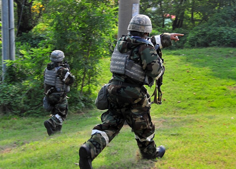 Airmen from the 51st Security Forces Squadron move toward enemy targets during an attack on hill 180 Sep. 01, 2011 during exercise Beverly-Midnight 11-04. Exercises such as this test Osan's ability to survive and operate during a war-time constraint. (U.S. Air Force photo/Senior Airman Adam Grant)  