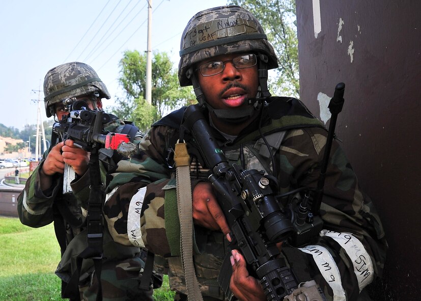 Tech. Sgt. Anthony Nixon, 51st Security Forces Squadron patrolman, prepares to engage enemy targets while his battle buddy gives him cover Sep. 01, 2011 during exercise Beverly-Midnight 11-04. Exercises such as this test Osan's ability to survive and operate during a war-time constraint. (U.S. Air Force photo/Senior Airman Adam Grant)  
