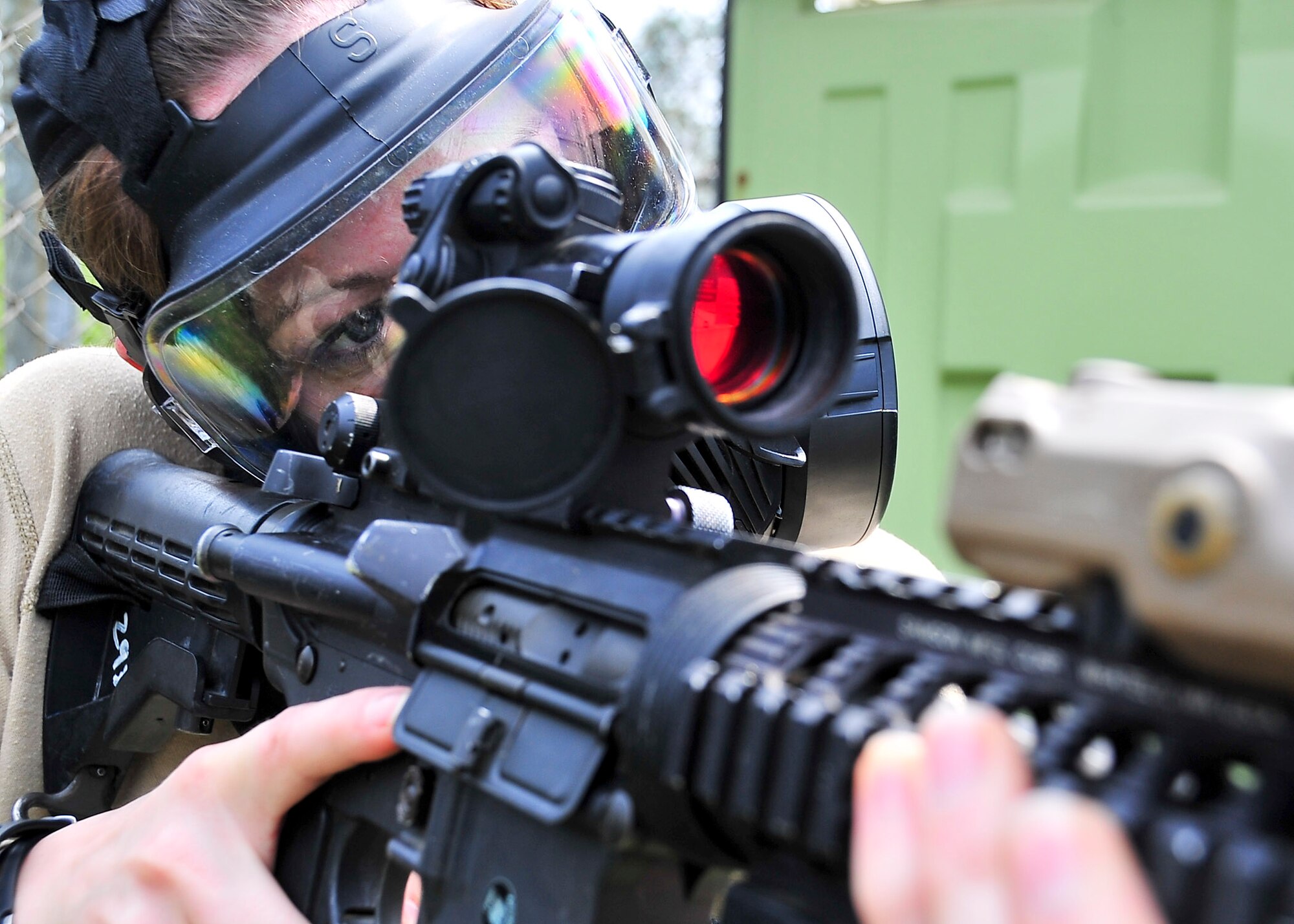 Senior Airman Courtney McClellan, 51st Security Forces Squadron base pass technician, checks her sight picture before preparing to attack hill 180 Sep. 01, 2011 during exercise Beverly-Midnight 11-04. Exercises such as this test Osan's ability to survive and operate during a war-time constraint. (U.S. Air Force photo/Senior Airman Adam Grant)  
