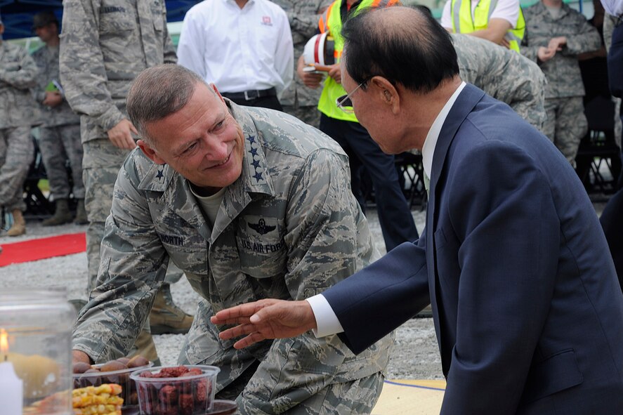 KUNSAN AIR BASE, Republic of Korea -- Gen. Gary L. North, Pacific Air Forces commander, participates in a Korean customary ceremony at the Distributive Mission Training (DMT) Flight Simulator groundbreaking ceremony to promote safety and good luck during construction of the facility here Aug. 22.  The general participated in the groundbreaking ceremony that marked the construction of the $7.5 million project. (U.S. Air Force photo/Staff Sgt. Rasheen Douglas)