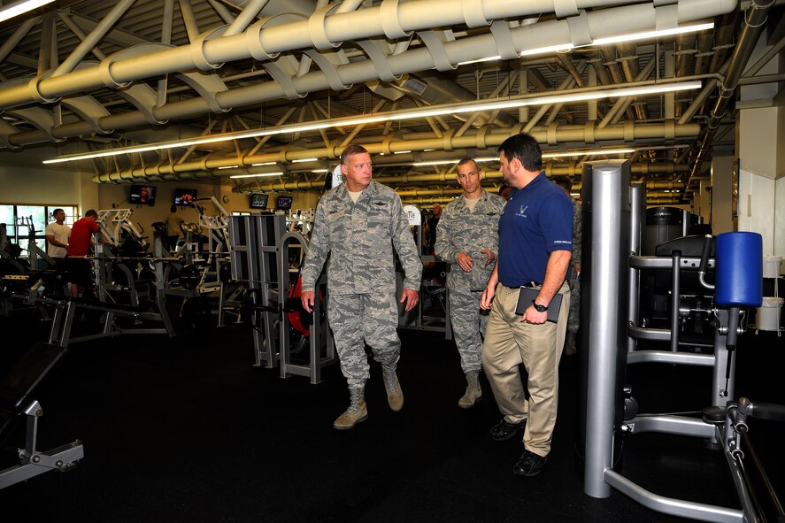 KUNSAN AIR BASE, Republic of Korea -- Gen. Gary L. North, Pacific Air Forces commander, and Col. Scott Pleus, 8th Fighter Wing commander, are briefed on services available to Wolf Pack members as they walk through the fitness center here Aug. 22.  The general toured facilities and spoke to Wolf Pack members to reiterate their importance and their roles during his visit to Kunsan.  (U.S. Air Force photo/Staff Sgt. Rasheen Douglas)