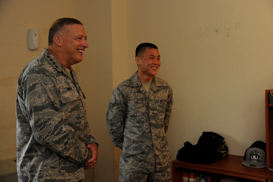 KUNSAN AIR BASE, Republic of Korea -- Gen. Gary L. North, Pacific Air Forces commander, visits Airman 1st Class Sulki Lee's dorm room to see the conditions of how some Wolf Pack Airmen are living here Aug. 22.  The general toured facilities and spoke to Wolf Pack members to reiterate their importance and their roles during his visit to Kunsan.  (U.S. Air Force photo/Staff Sgt. Rasheen Douglas)