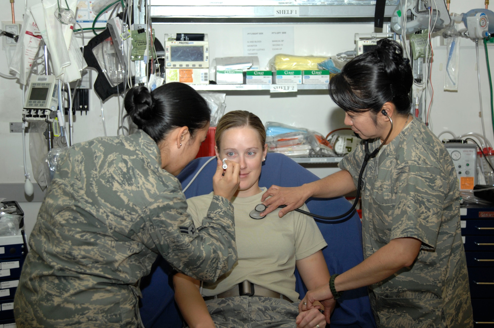 Airman 1st Class Diana Munar and Maj. Leila Von Kreitor, both from the 332nd Expeditionary Medical Group, take vitals on a patient at the Air Force Theater Hospital at Joint Base Balad, Iraq. Von Kreitor decided to join the Air Force after feeling helpless during the 9/11 attacks in New York. Munar is deployed from Lackland Air Force Base, Texas, and is a native of Lake Grove, N.Y. Von Kreitor is deployed from Andrews AFB, Md., and is a native of Staten Island, N.Y. (U.S. Air Force photo by Senior Airman Amber R. Kelly-Herard) 


