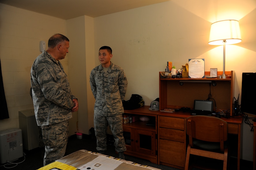KUNSAN AIR BASE, Republic of Korea -- Gen. Gary L. North, Pacific Air Forces commander, visits Airman 1st Class Sulki Lee's dorm room to see the conditions of how some Wolf Pack Airmen are living here Aug. 22.  The general toured facilities and spoke to Wolf Pack members to reiterate their importance and their roles during his visit to Kunsan.  (U.S. Air Force photo/Staff Sgt. Rasheen Douglas)