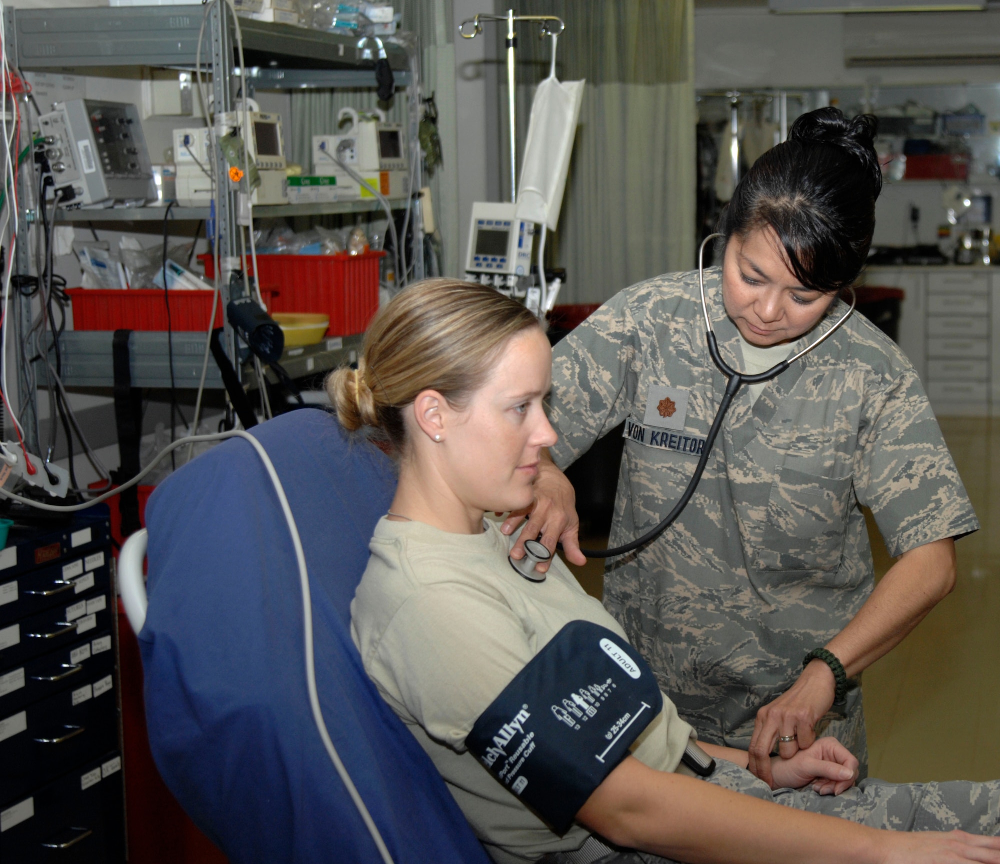 Maj. Leila Von Kreitor, 332nd Expeditionary Medical Group Intensive Care Unit and Intensive Care Ward officer in charge, checks vitals on a patient at the Air Force Theater Hospital at Joint Base Balad, Iraq. Von Kreitor was living in New York, Sept. 11, 2001, and joined the Air Force as a result of 9/11. (U.S. Air Force photo by Senior Airman Amber R. Kelly-Herard) 


