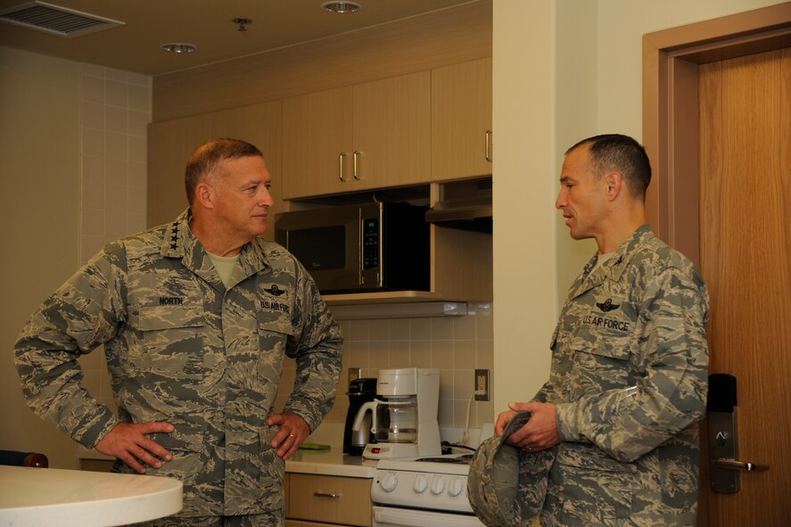 KUNSAN AIR BASE, Republic of Korea -- Gen. Gary L. North, Pacific Air Forces commander, listens as Col. Scott Pleus, 8th Fighter Wing commander, talks about the new dormitories and the better quality of life they offer for Wolf Pack members here Aug. 22.  During his visit, the general toured facilities and spoke to Wolf Pack members to reiterate their importance and roles.  (U.S. Air Force photo/Staff Sgt. Rasheen Douglas)