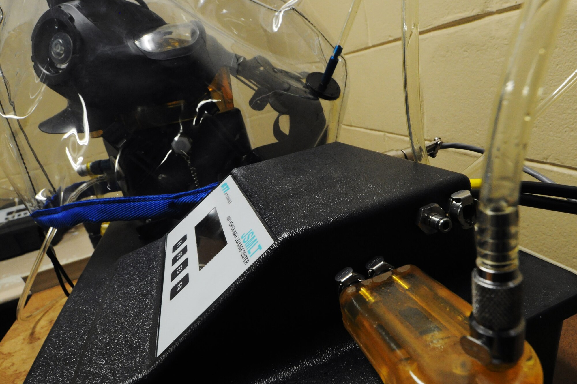 KUNSAN AIR BASE, Republic of Korea -- Senior Airman Alyse Bell, 8th Logistics Readiness Squadron individual protection equipment clerk, prepares a gas mask for a leakage test using a joint service mask leakage tester here Sept. 1. The JSMLT is a portable tool used to aid the war fighter to determine leakage and fit of protective masks. (U.S. Air Force photo/Senior Airman Brittany Y. Bateman)
