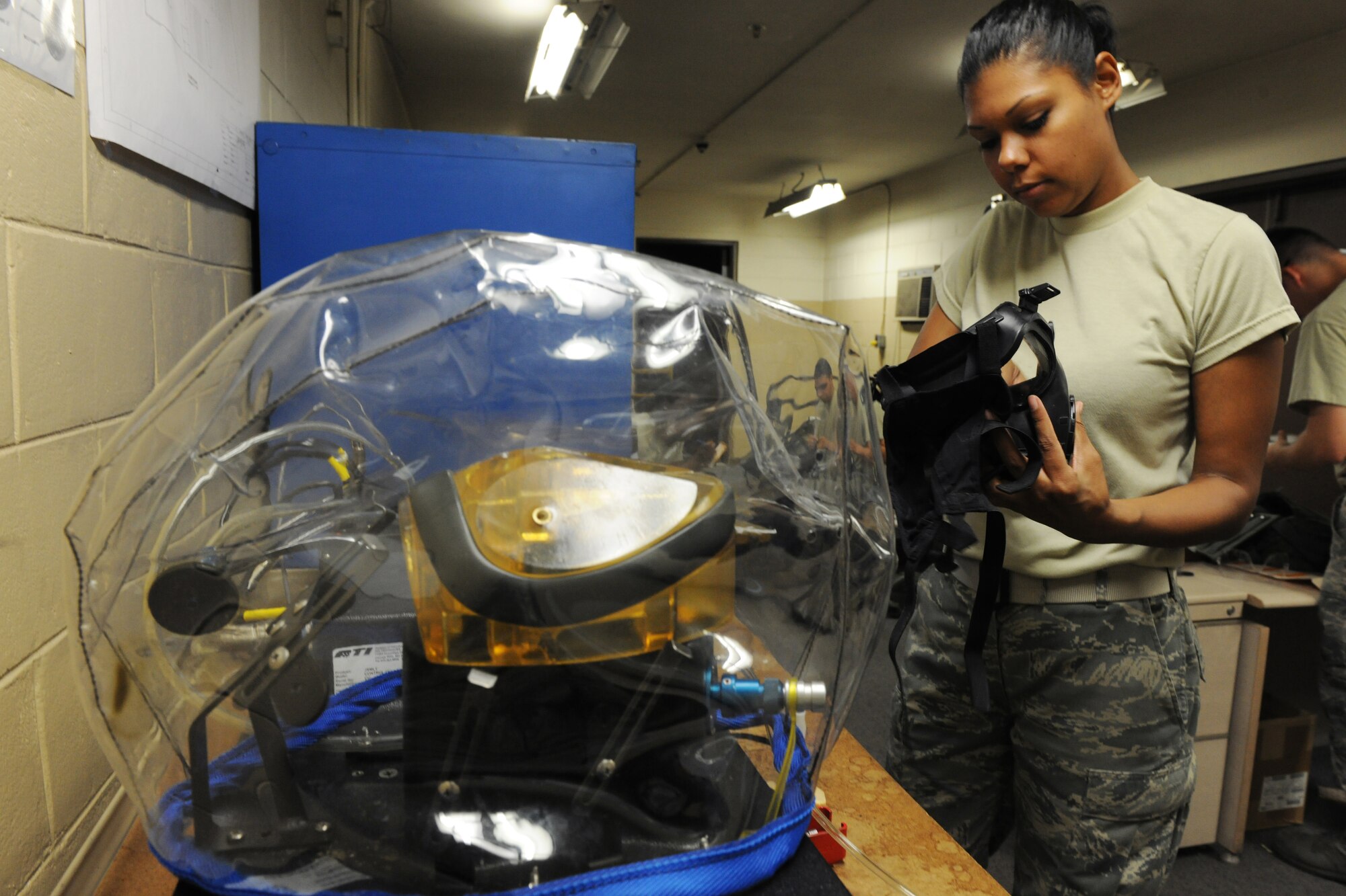 KUNSAN AIR BASE, Republic of Korea -- Senior Airman Alyse Bell, 8th Logistics Readiness Squadron individual protection equipment clerk, prepares a gas mask for a leakage test using a joint service mask leakage tester here Sept. 1. The JSMLT is a portable tool used to aid the war fighter to determine leakage and fit of protective masks. (U.S. Air Force photo/Senior Airman Brittany Y. Bateman)
