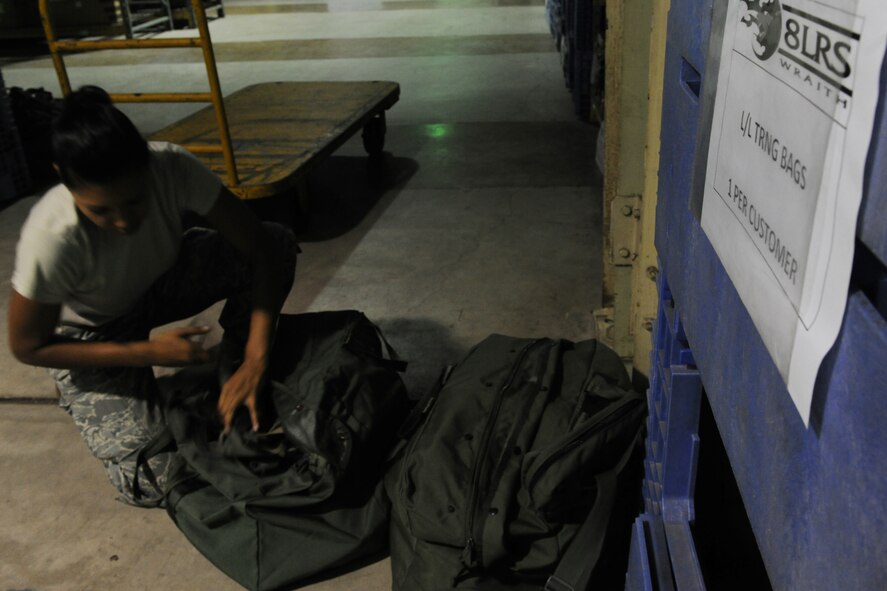 KUNSAN AIR BASE, Republic of Korea -- Senior Airman Alyse Bell, 8th Logistics Readiness Squadron individual protection equipment clerk, builds training chemical gear bags for newcomers arriving on the Patriot Express here Sept. 1. From in-processing and out-processing to taking inventory, these Airmen guarantee the Wolf Pack is able to survive a mortar or chemical attack. (U.S. Air Force photo/Senior Airman Brittany Y. Bateman)