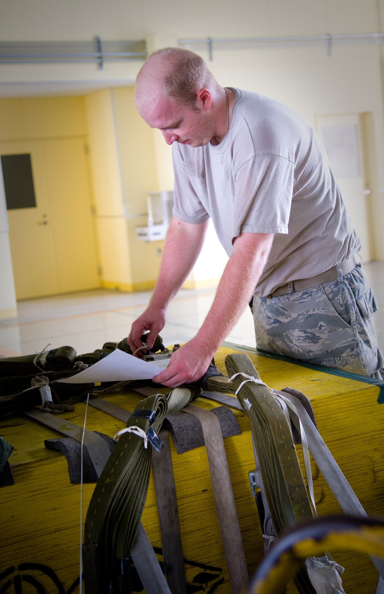 YOKOTA AIR BASE, Japan-- Senior Airman Brandon Wilson, 374th Logistics Readiness Squadron combat mobility fight rigger, checks the rigger inspection list while inspecting heavy load equipment Sept. 1, 2011, at Yokota Air Base, Japan. (U.S. Air Force photo/Airman 1st Class Krystal M. Garrett) 