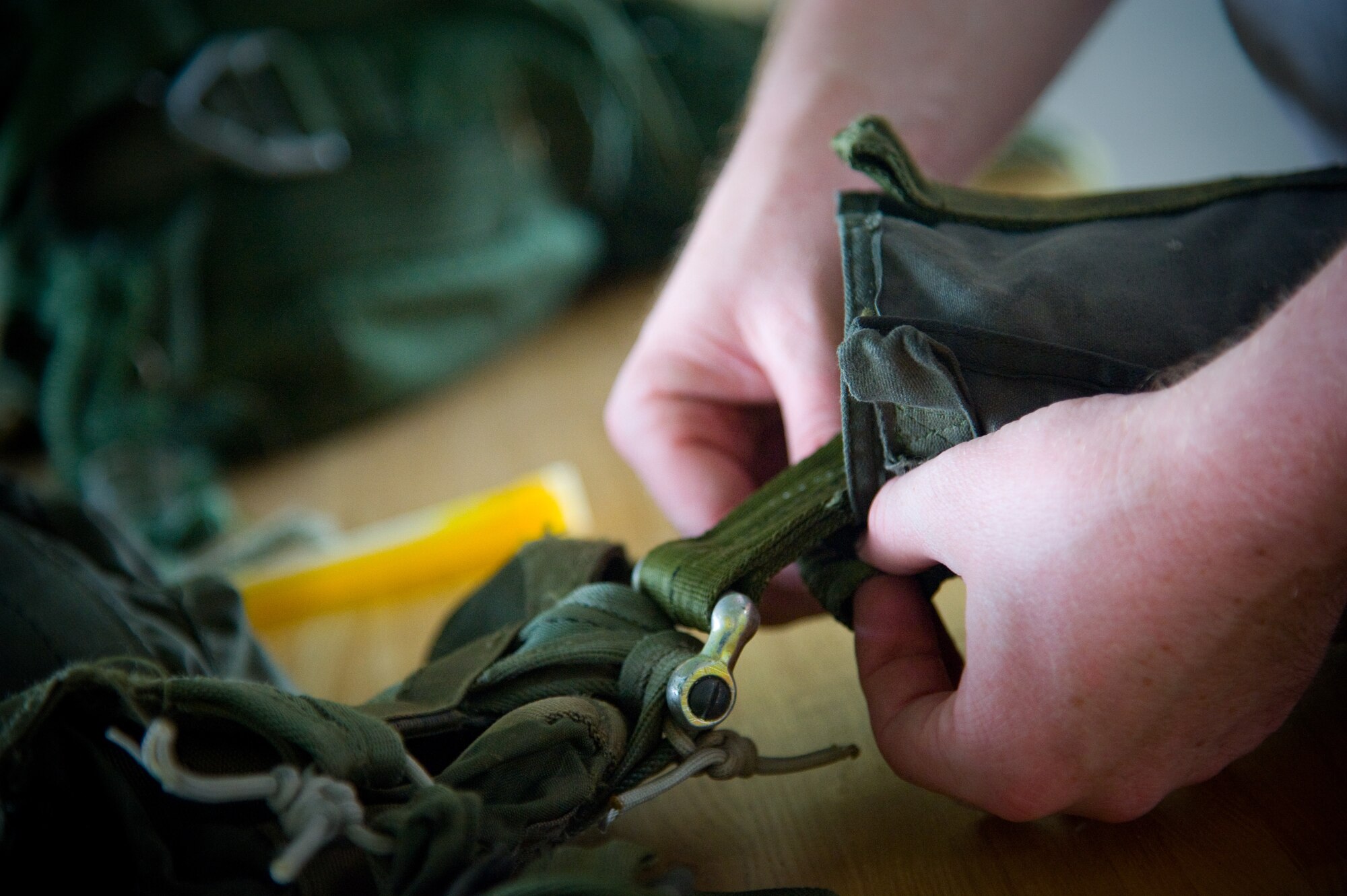 YOKOTA AIR BASE, Japan-- Senior Airman Brandon Wilson, 374th Logistics Readiness Squadron combat mobility flight rigger, prepares a standard airdrop training bundle at Yokota Air Base, Japan, Sept. 1, 2011. The airdrop bundles are used to simulate personnel drops. (U.S. Air Force photo/Airman 1st Class 