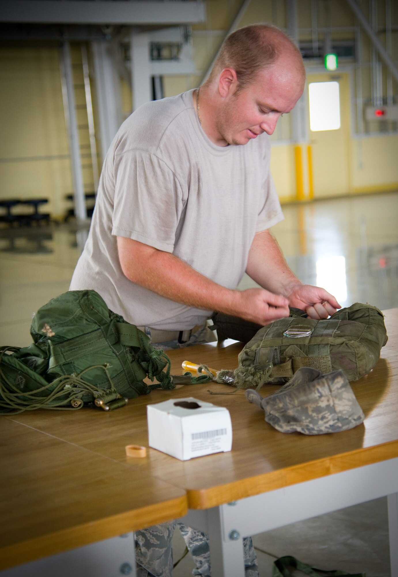 YOKOTA AIR BASE, Japan-- Senior Airman Brandon Wilson, 374th Logistics Readiness Squadron combat mobility flight rigger, prepares a standard airdrop training bundle at Yokota Air Base, Japan, Sept. 1, 2011. The airdrop bundles are used to simulate personnel drops. (U.S. Air Force photo/Airman 1st Class 